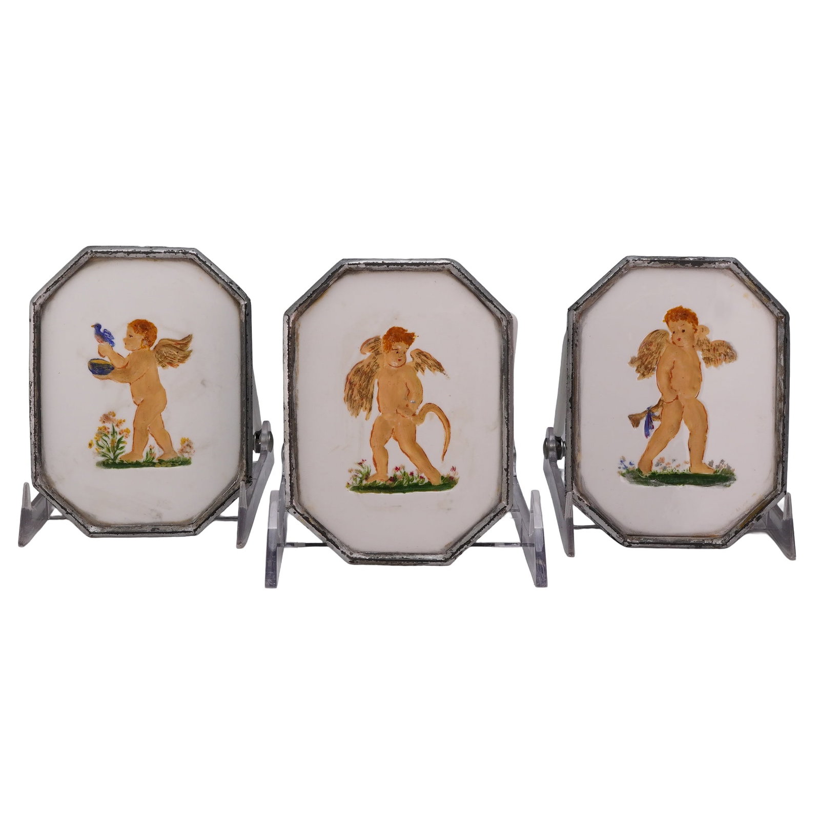 3pc Wedgwood Hand-Painted Porcelain Miniature Plaques with Cherubs: A trio of miniature porcelain plaques, each of octagonal form and featuring a hand-painted depiction of a winged cherub or putto. The figures are set against a plain white ground with small tufts of g