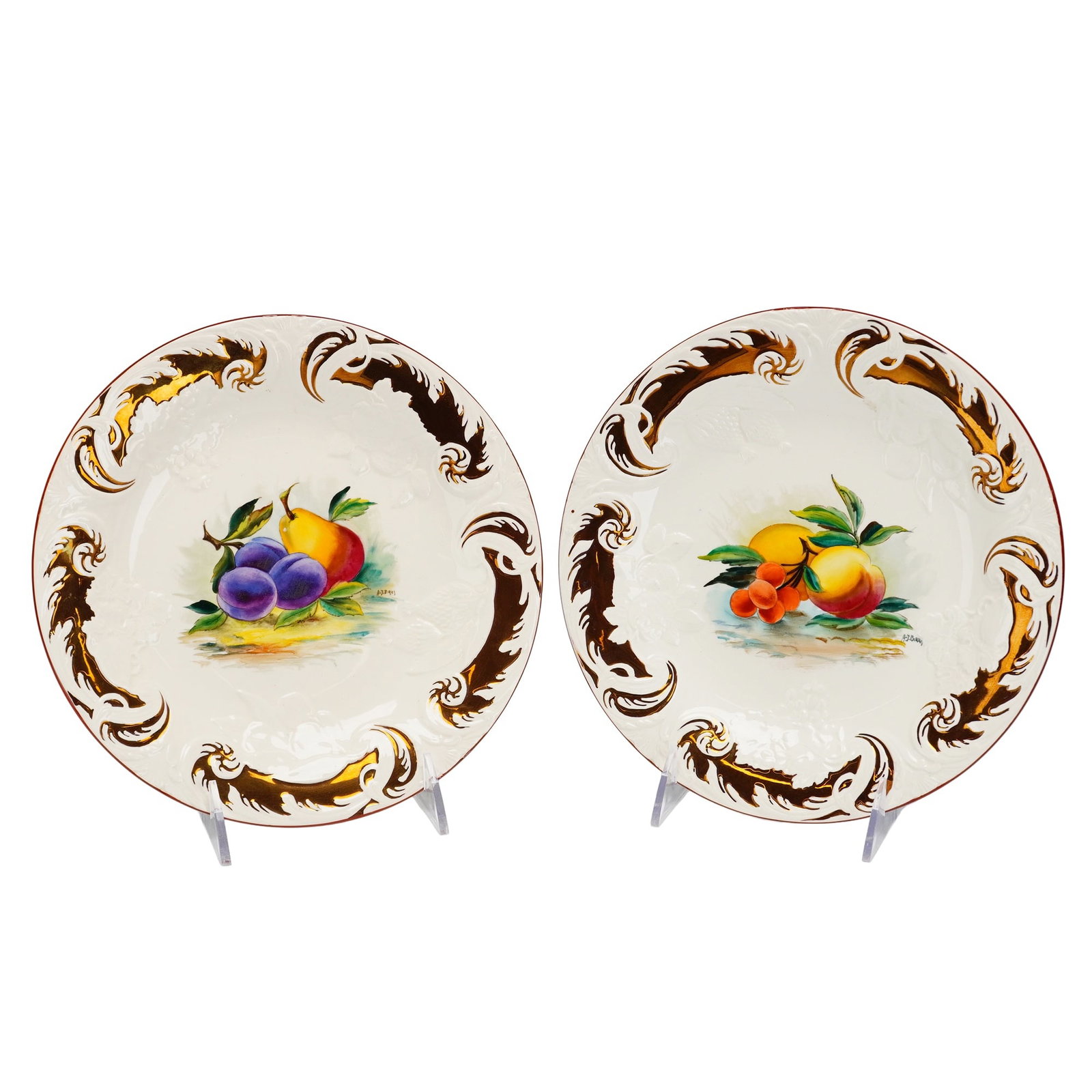 Pair of Wedgwood Etruria Queen's Ware Dessert Plates: This pair of dessert plates is crafted from fine cream-colored earthenware, known as Queen's Ware, produced by Wedgwood at the Etruria works in England. Each plate features a central, hand-painted fru