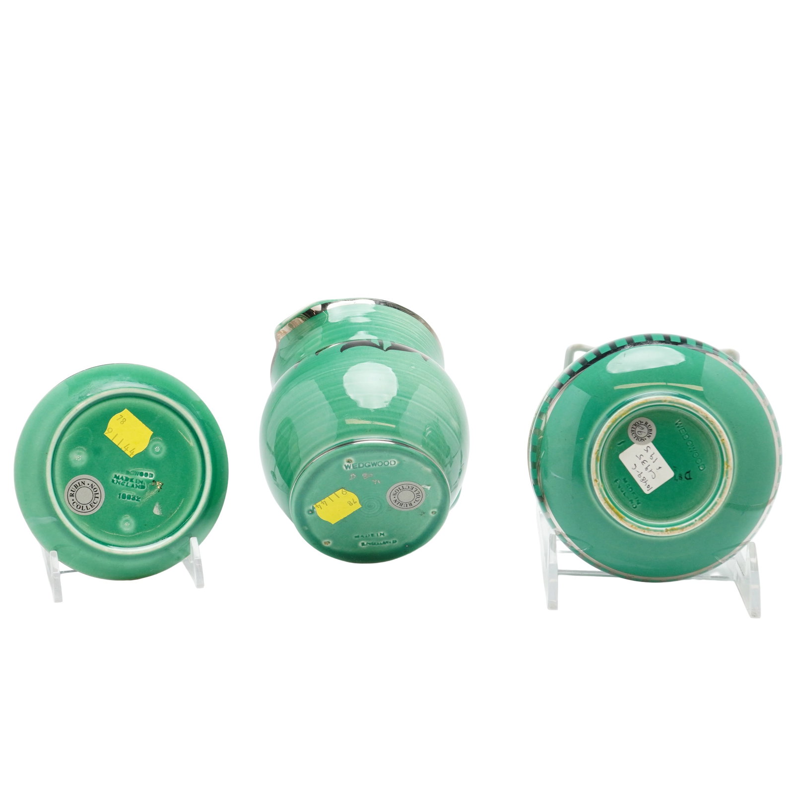Three Wedgwood Green Veronese Tableware- Pitcher, Covered Dish and Small Plate: This three-piece group of Wedgwood glazed earthenware consists of a small pitcher, a bowl, and a lid. The items are finished in a uniform vibrant green glaze. Decorative elements include a black styli