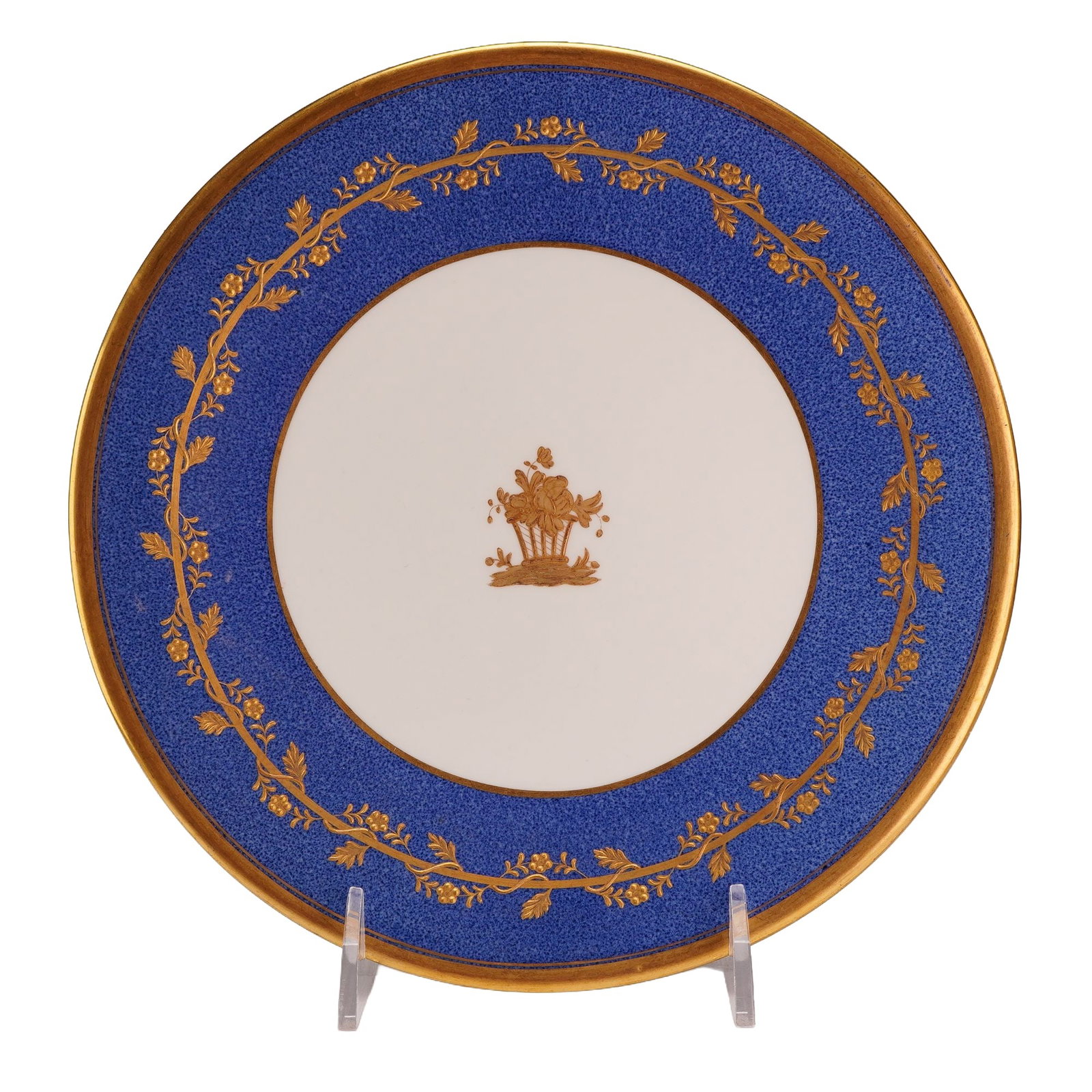Wedgwood Powder Blue and Gilt Porcelain Cabinet Plate: This Wedgwood fine porcelain cabinet plate features a central gilded motif of a floral basket. The wide rim is decorated with a powder blue mottled ground overlaid with an ornate, continuous gilded vi