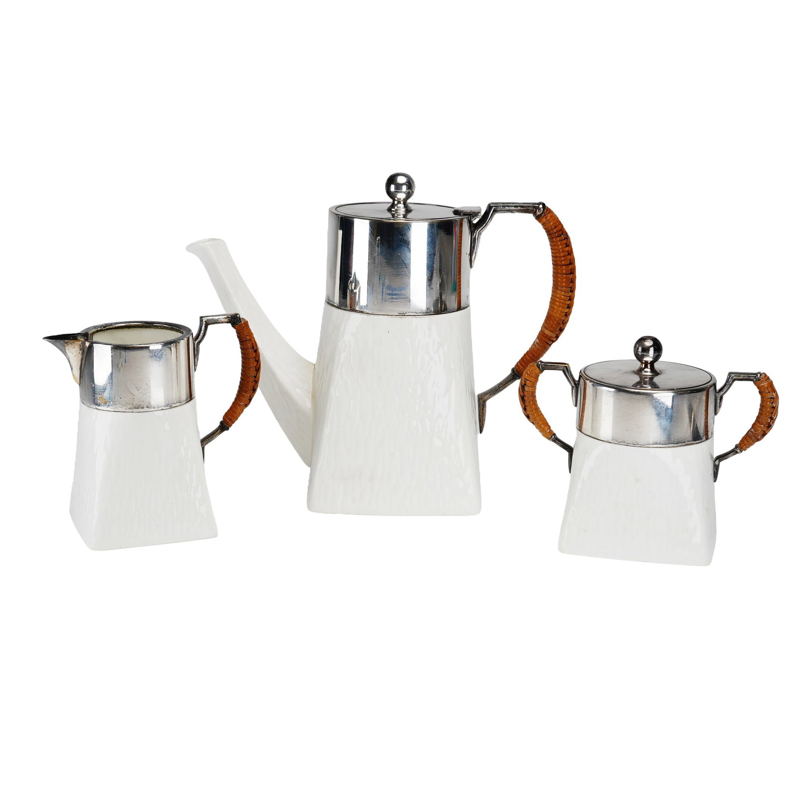 A Three-Piece Wedgwood Ceramic Coffee Pot, Creamer, and Sugar Bowl with F.W. Quist Silver-Plated: This three-piece service includes a tall coffee pot, a small creamer, and a sugar bowl with a removable lid. Each piece is constructed with a tapered square ceramic body featuring a molded vertical ba