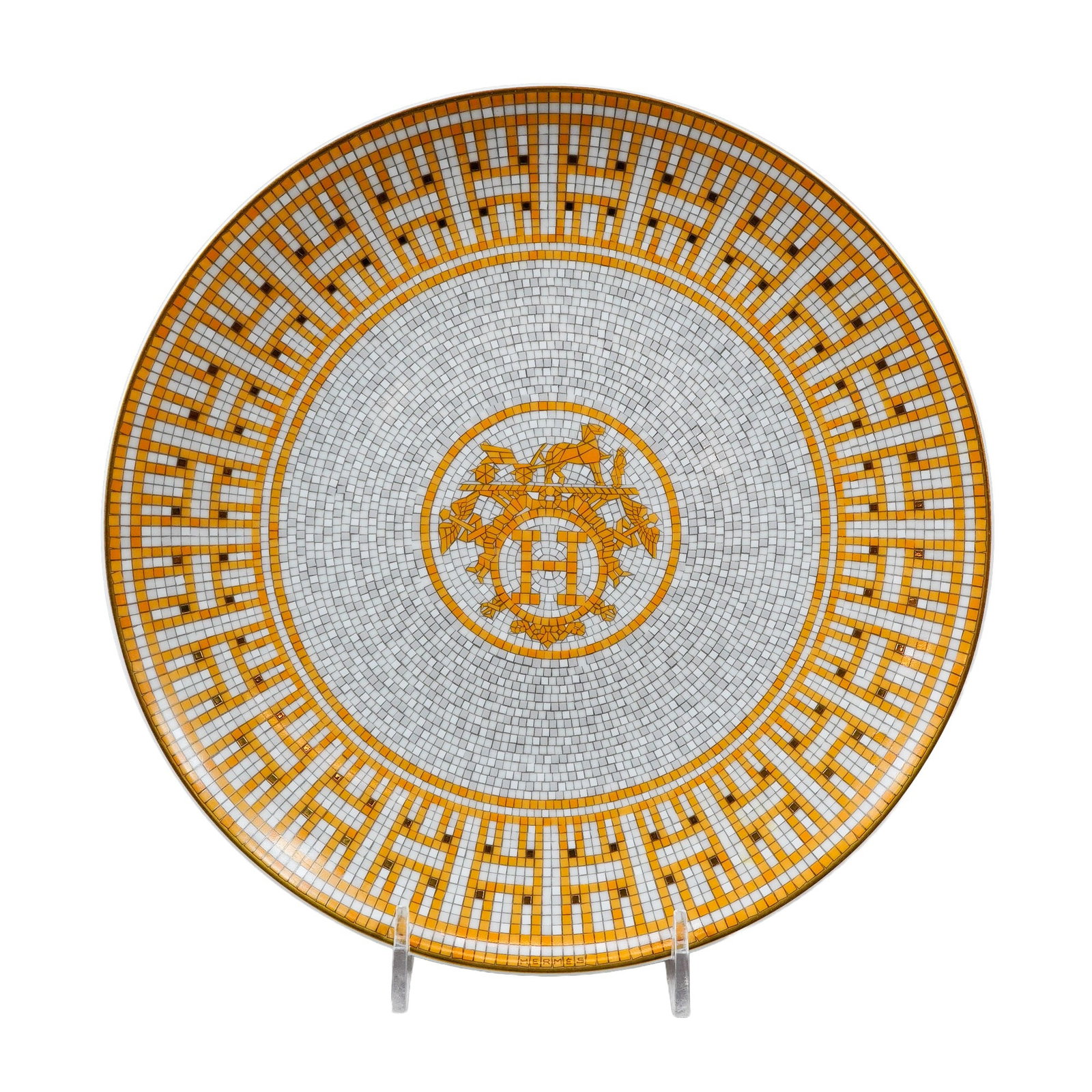 Hermes Mosaique au 24 Gold Porcelain Salad Plate: Hermes, France. Circular dessert plate in fine porcelain, featuring the Mosaique au 24 pattern. The design consists of a geometric mosaic in shades of ochre, yellow, grey, and white, highlighted with 