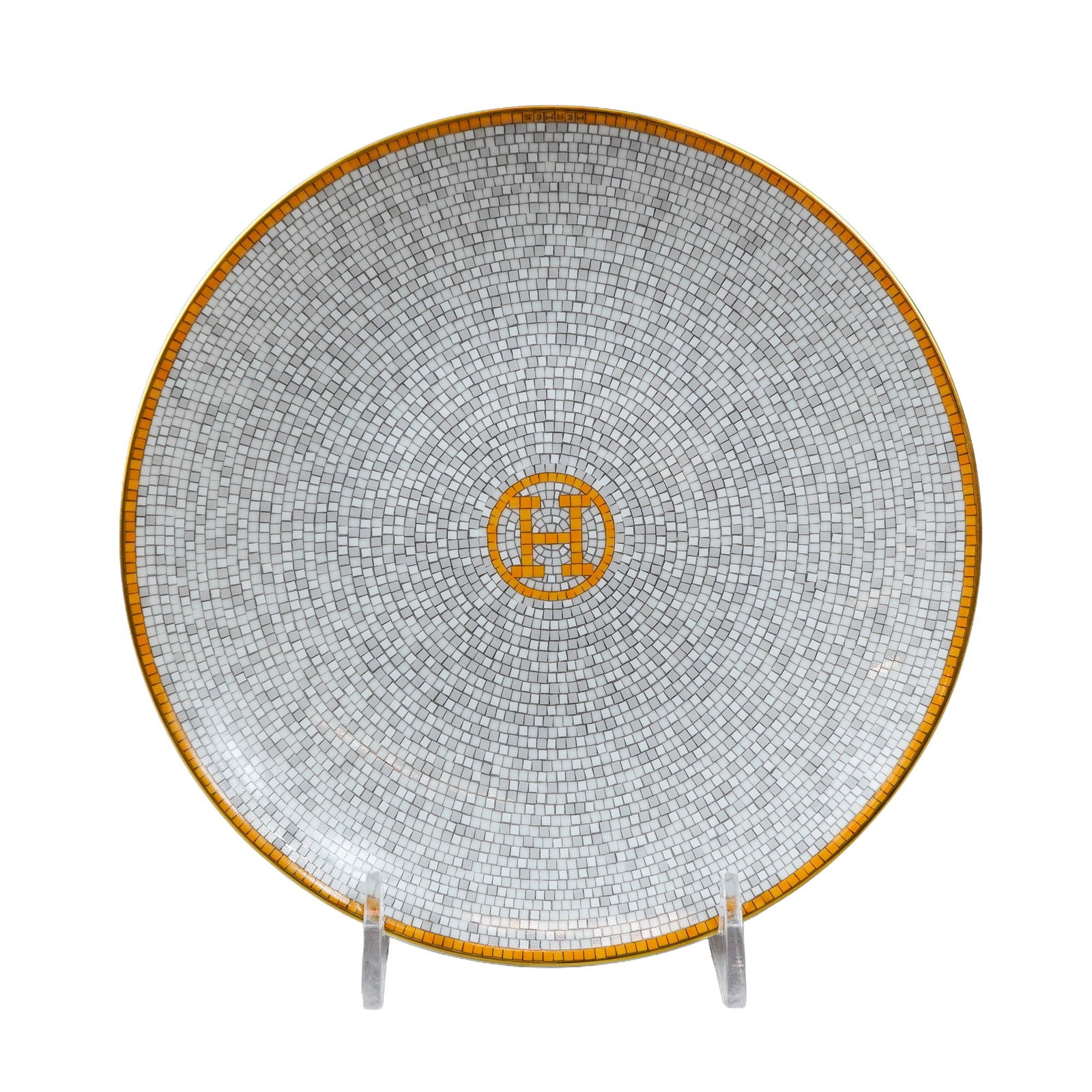 Hermes Mosaique au 24 Gold Porcelain Bread and Butter Plate: Hermes (Paris, France) porcelain plate from the Mosaique au 24 collection, featuring a gray and white mosaic ground pattern. The design is accented by a central ochre and gold-toned mosaic medallion d