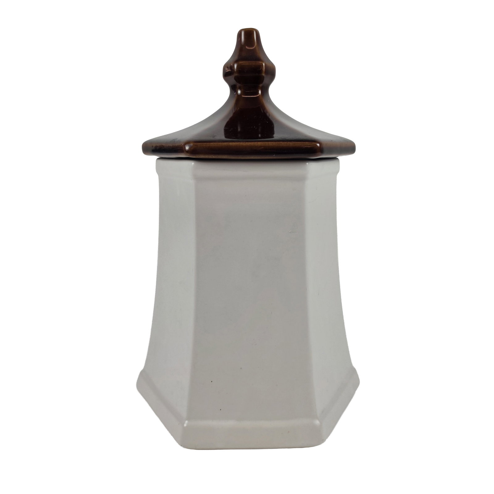McCoy Pagoda Sunflower Ceramic Canister: Hexagonal pagoda-style kitchen canister in glazed earthenware, featuring a tapered cream-colored body and a contrasting chocolate brown hexagonal lid with a molded finial. One face is decorated with a
