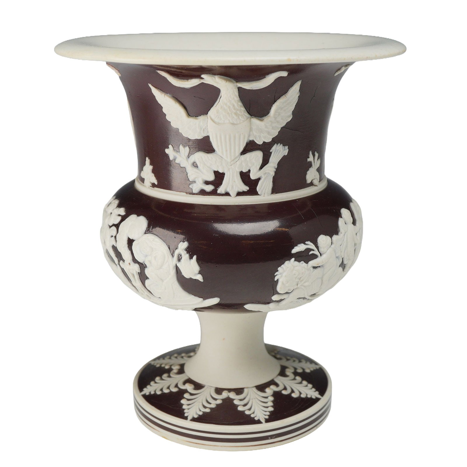 Early 19th Century English Slip Glazed Neoclassical Jasperware Footed Vase: Enlish slip glazed jasperware footed vase of campana form, featuring a deep chocolate brown body with applied white sprigged decoration. The upper flared portion is decorated on one side with the Grea
