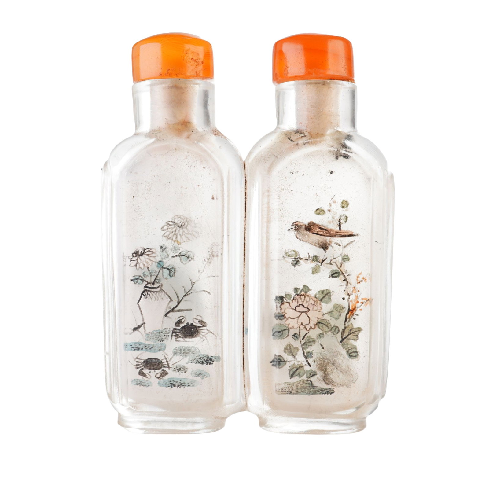 Inside Painted Glass Double Snuff Bottle, Bird and Flowers: A double glass snuff bottle featuring interior paintings on each side, showcasing hilly landscapes, flowers in a vase with crabs, and a bird perched on a branch. It is paired with two orange stoppers.
