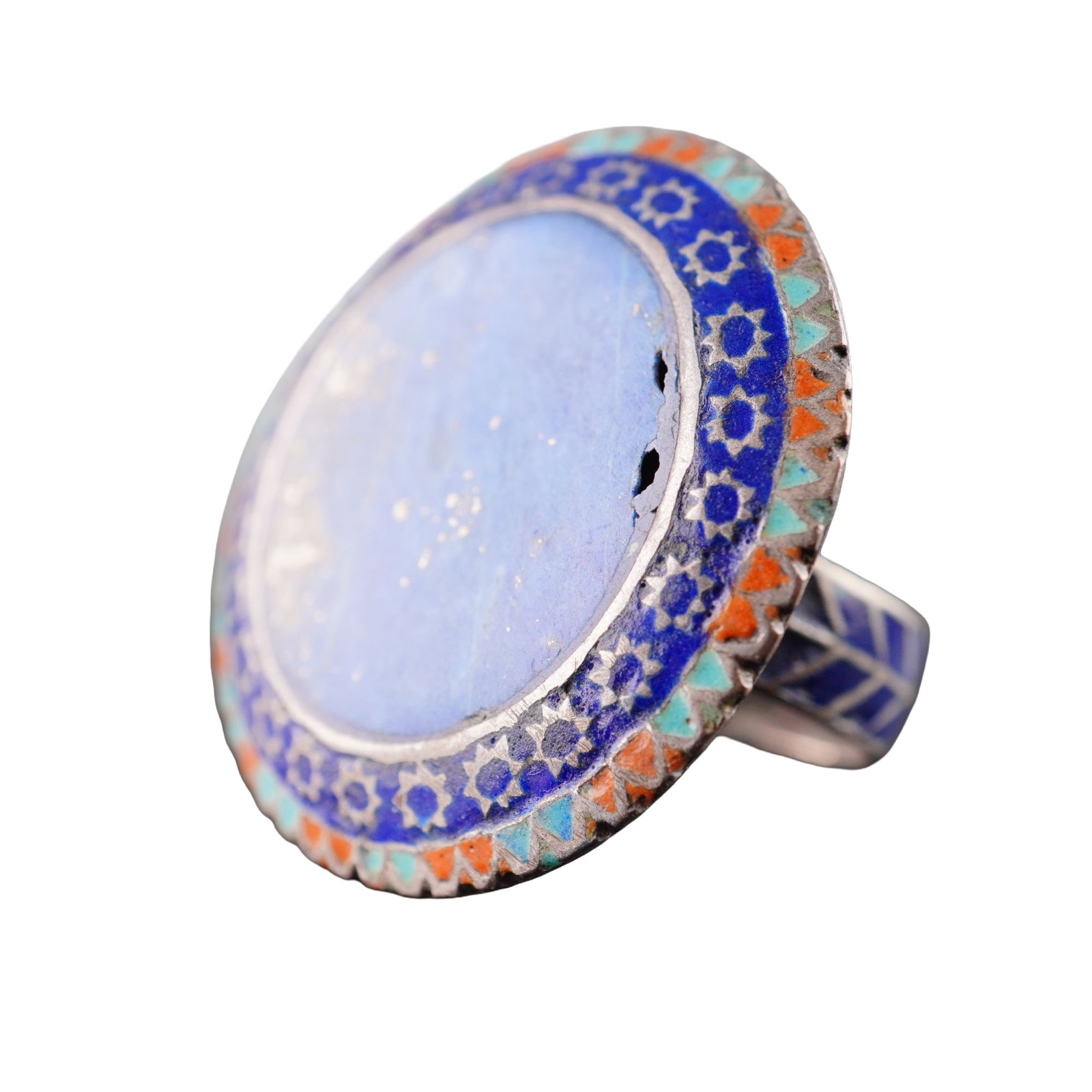 Large Pakistan Lapis Lazuli Statement Ring in the Style of Multan: This is a large, circular statement ring featuring a central lapis lazuli cabochon, in the craft traditions of Multan, Pakistan. The ring is constructed from a silver-toned white metal. The central fl