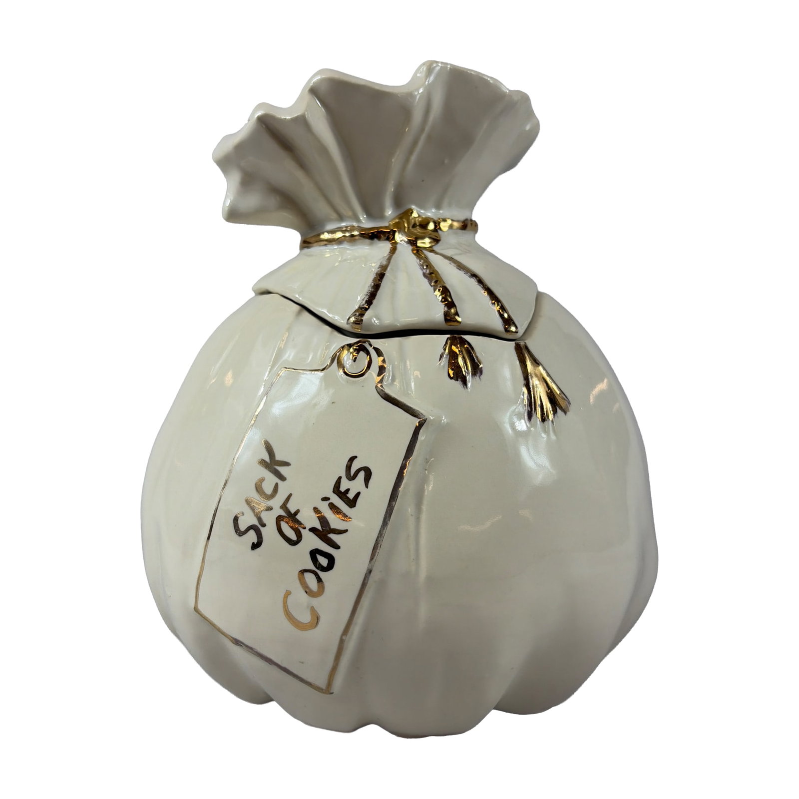 McCoy Ceramic Sack of Cookies Cookie Jar: Designed in the form of a gathered and tied sack. The piece features a cream-colored glazed ceramic body with gold-tone luster highlights. The lid is molded to resemble the top of a bag with a decorat