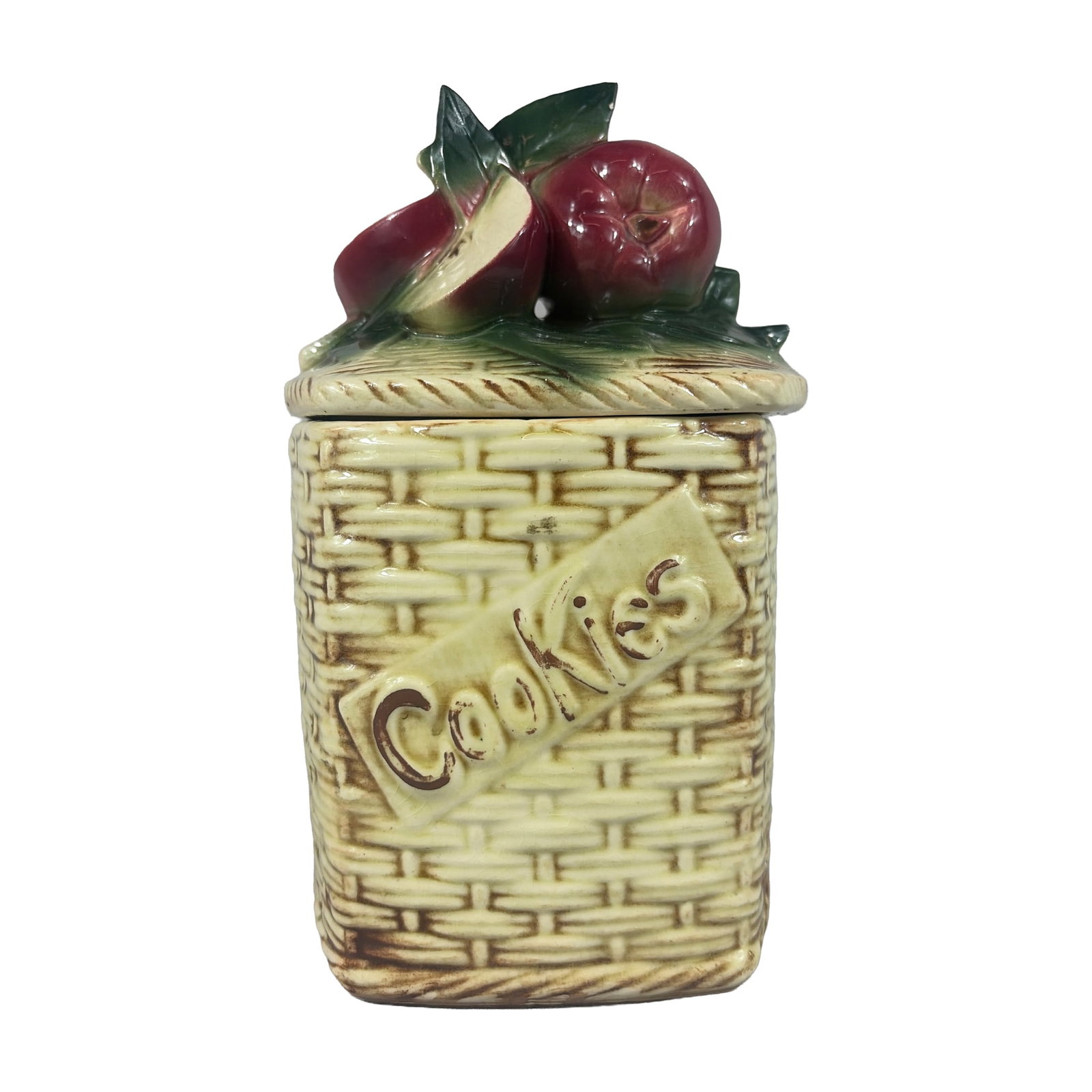 McCoy Pottery Apple Basketweave Ceramic Cookie Jar: Hexagonal glazed earthenware cookie jar featuring a molded basketweave motif accentuated with brown tones over a cream ground. One face is ornamented with a raised rectangular plaque displaying the wo