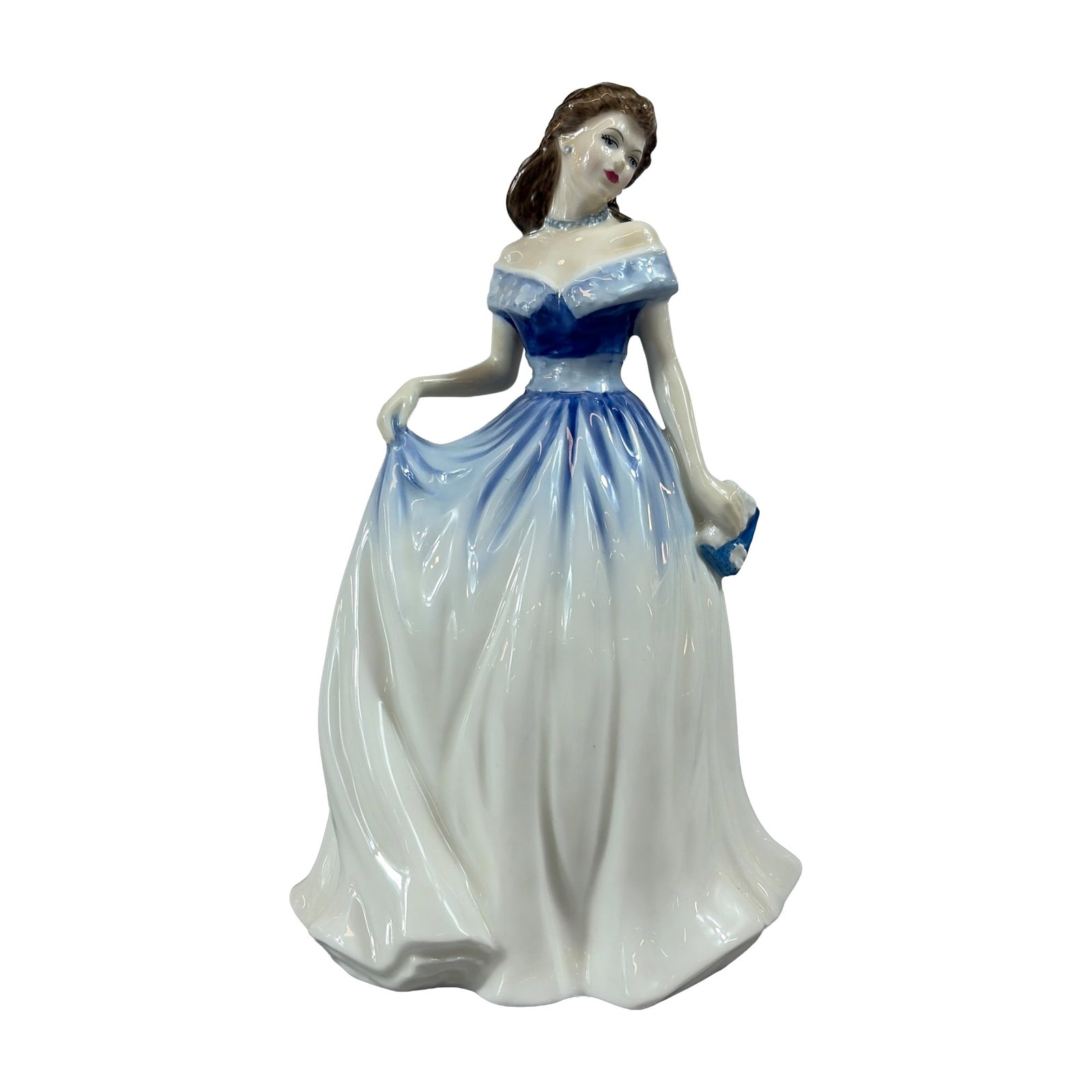 Royal Doulton Bone China Figurine, Charlotte HN4092: Featuring a woman in a formal off-the-shoulder gown with a cornflower blue bodice and shaded white skirt. The figure is posed holding a blue clutch in the left hand and lifting the skirt hem with the 
