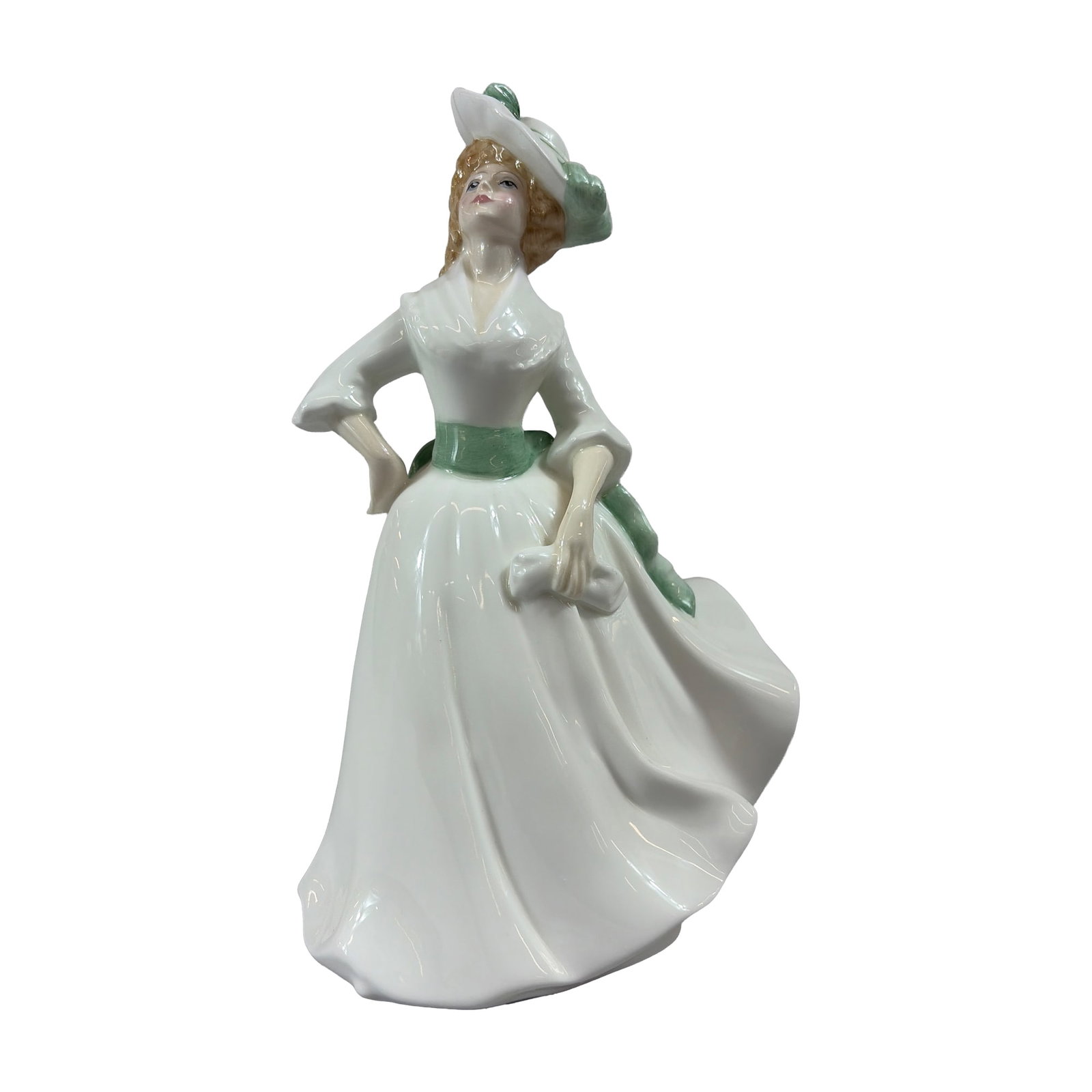 Royal Doulton Bone China Figurine, Margaret HN3496: The figure depicts a woman wearing a white dress with a green sash, matching back bow, and a wide brimmed white hat trimmed in green. The base is marked with the printed Royal Doulton backstamp. Dimen