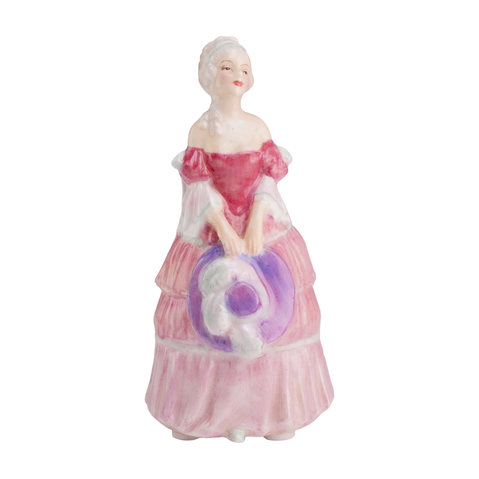 Royal Doulton Miniature Figurine Veronica: The piece depicts a female figure in a period-style three-tiered pink gown with an off-the-shoulder bodice. She is posed standing, holding a wide-brimmed purple and white hat with both hands at her wa
