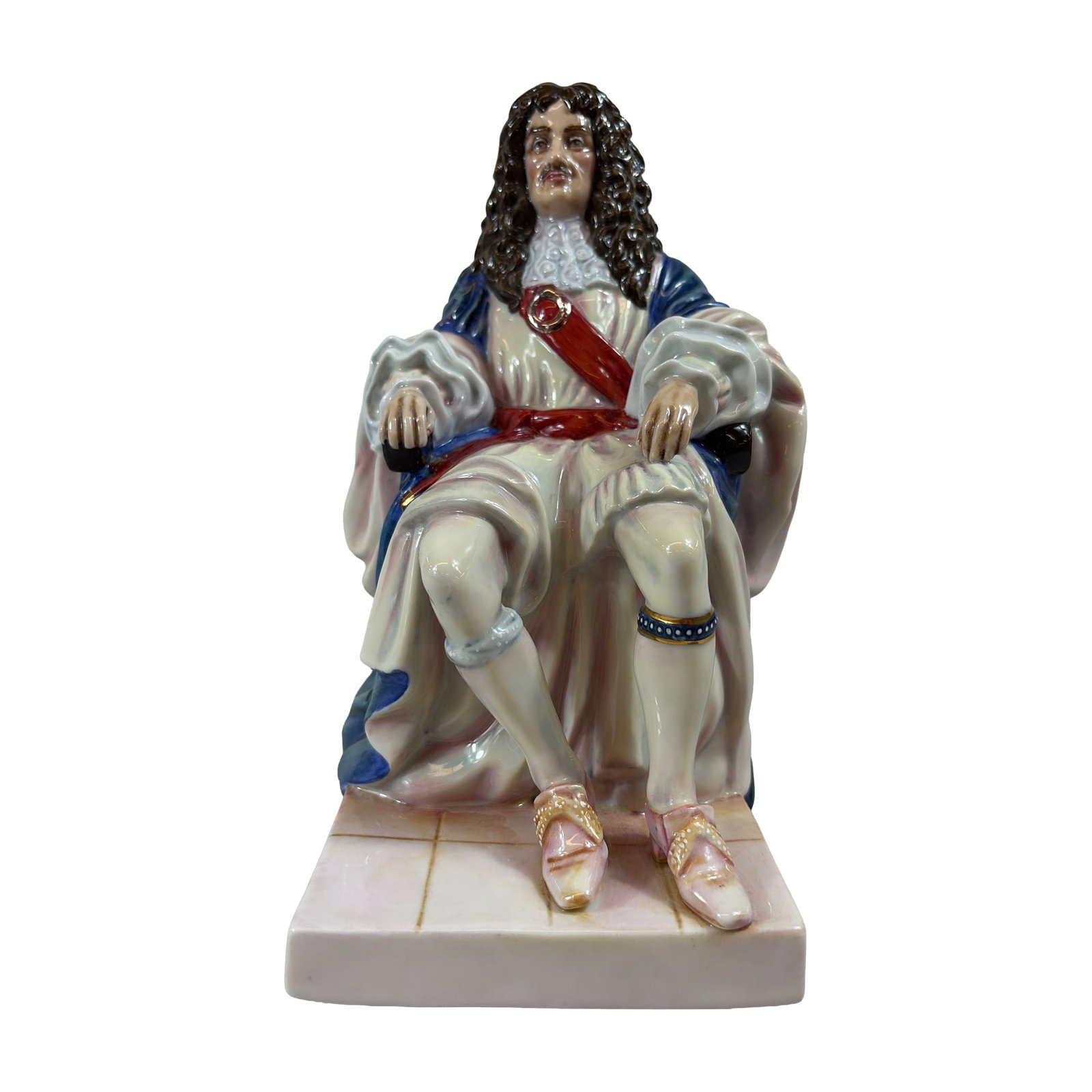 Royal Doulton Porcelain Figurine, King Charles II HN3825: Royal Doulton. Figurine in hand-decorated glazed porcelain, titled King Charles II (HN 3825) from The Stuarts series. The monarch is depicted seated on an ornate high-backed blue chair with gilded scr