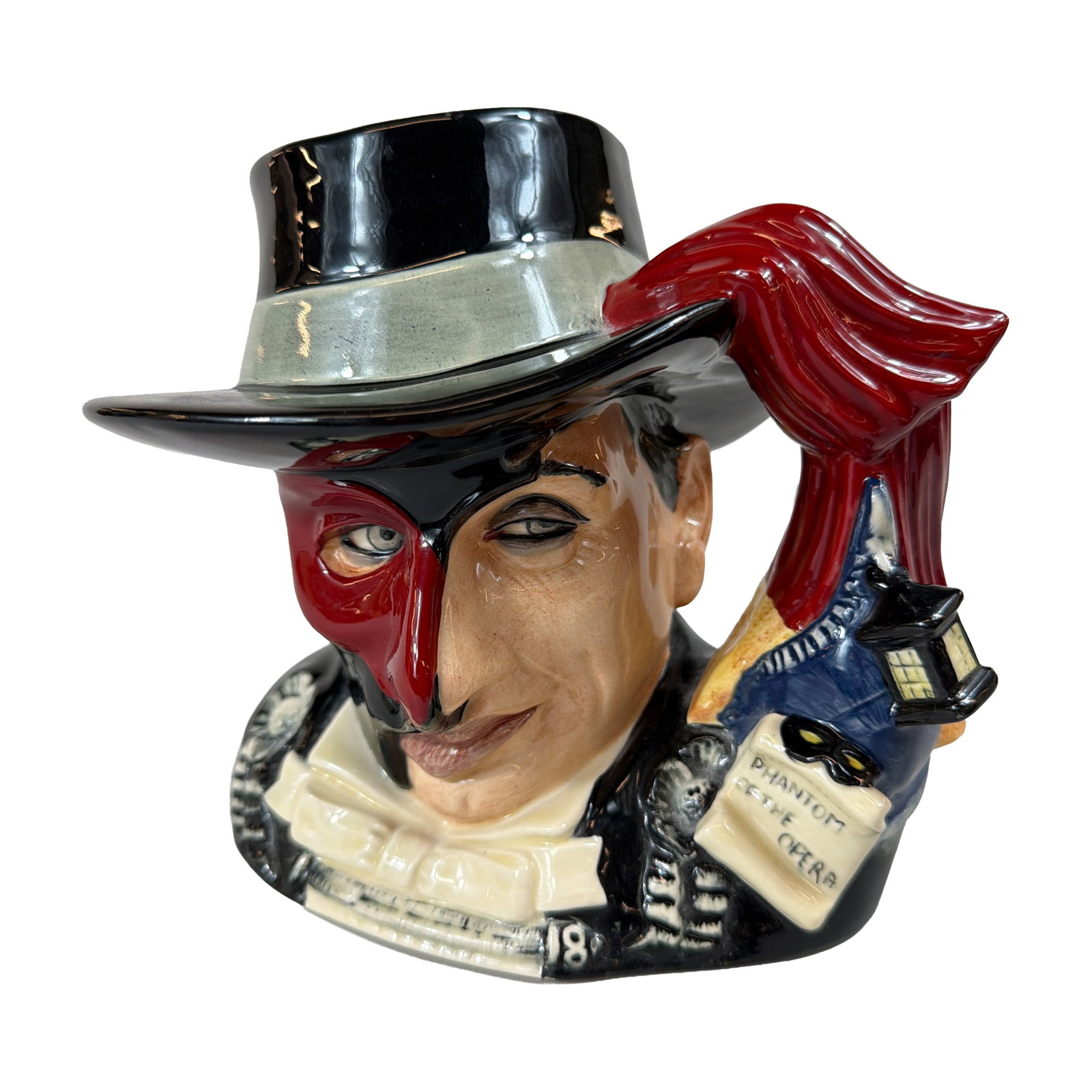 Royal Doulton Phantom of the Opera Ceramic Character Jug: Royal Doulton limited edition ceramic character jug, model D7017, depicting The Phantom of the Opera in his masquerade costume as the Red Death. The character is modeled wearing a black top hat, a bla