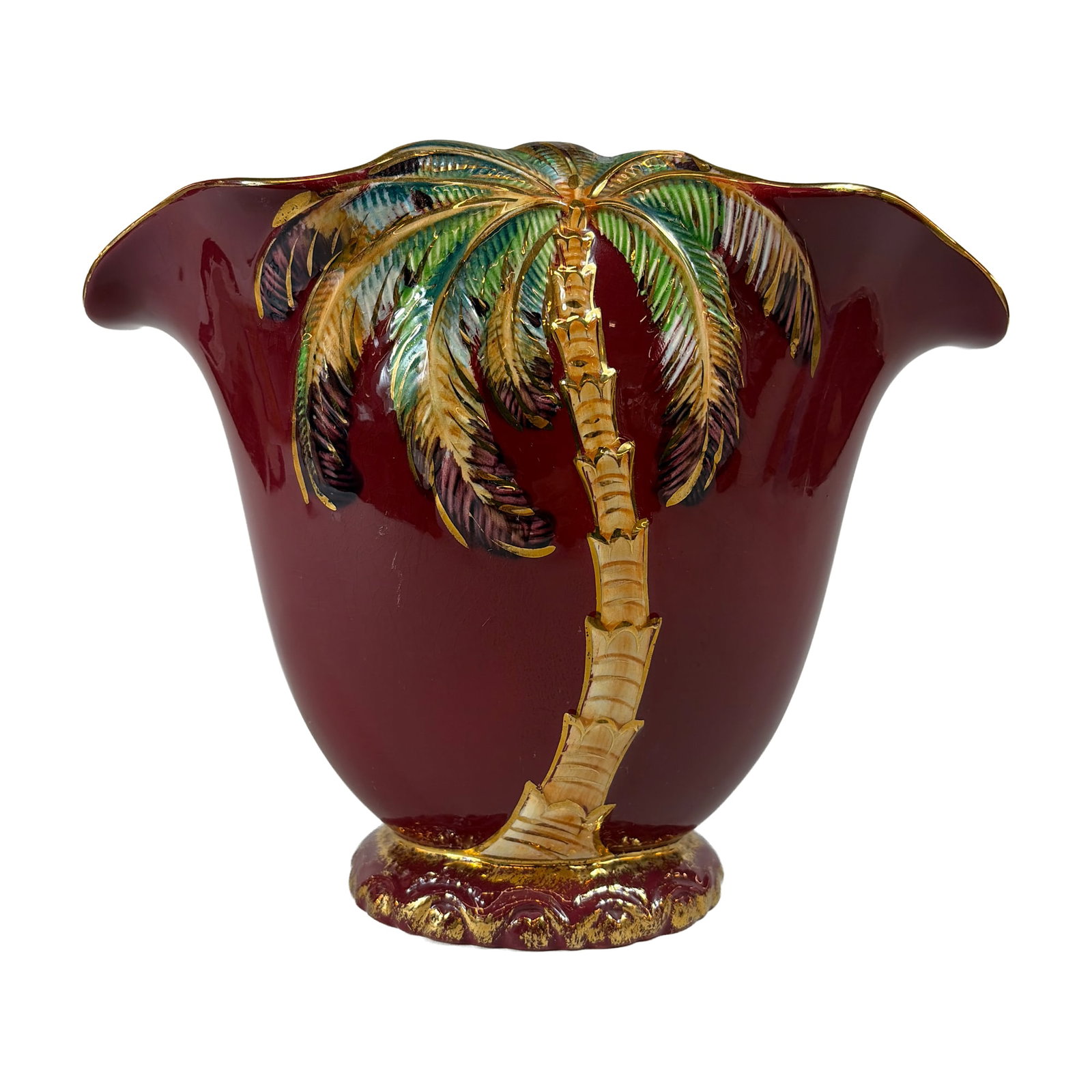 Beswick English Art Deco Palm Tree Vase, 1069: Footed fan-shaped vase in glazed earthenware, featuring a relief-molded palm tree motif. The vessel has a deep maroon exterior with hand-painted foliage in green and yellow, highlighted with gilded ac