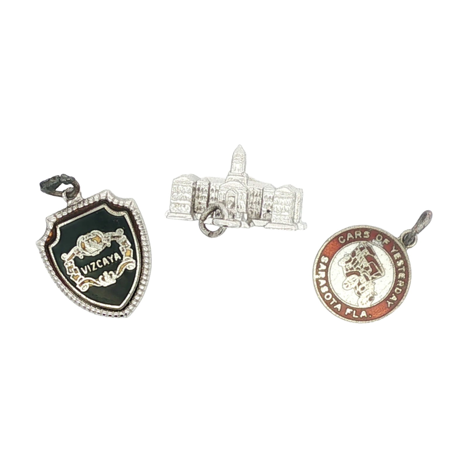 3pc Sterling Silver Florida Charms: A group of sterling silver charms representing iconic places in Florida. The collection includes charms for Sarasota, Vizcaya, and a charm modeled after the Florida State Capitol building. Dimensions: