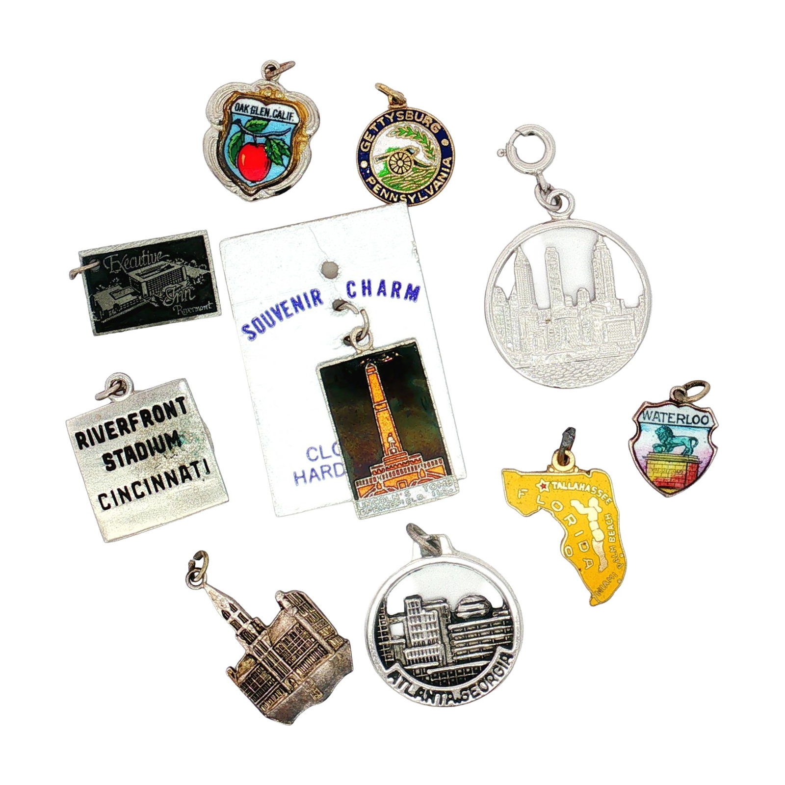 10pc U.S. and Belgian Souvenir Charms: A collection of charms featuring cities, states, and landmarks from the U.S. and Belgium including Atlanta, Florida, the Cincinnati Riverfront Stadium, the Brussels Town Hall, and more. Dimensions: 1.