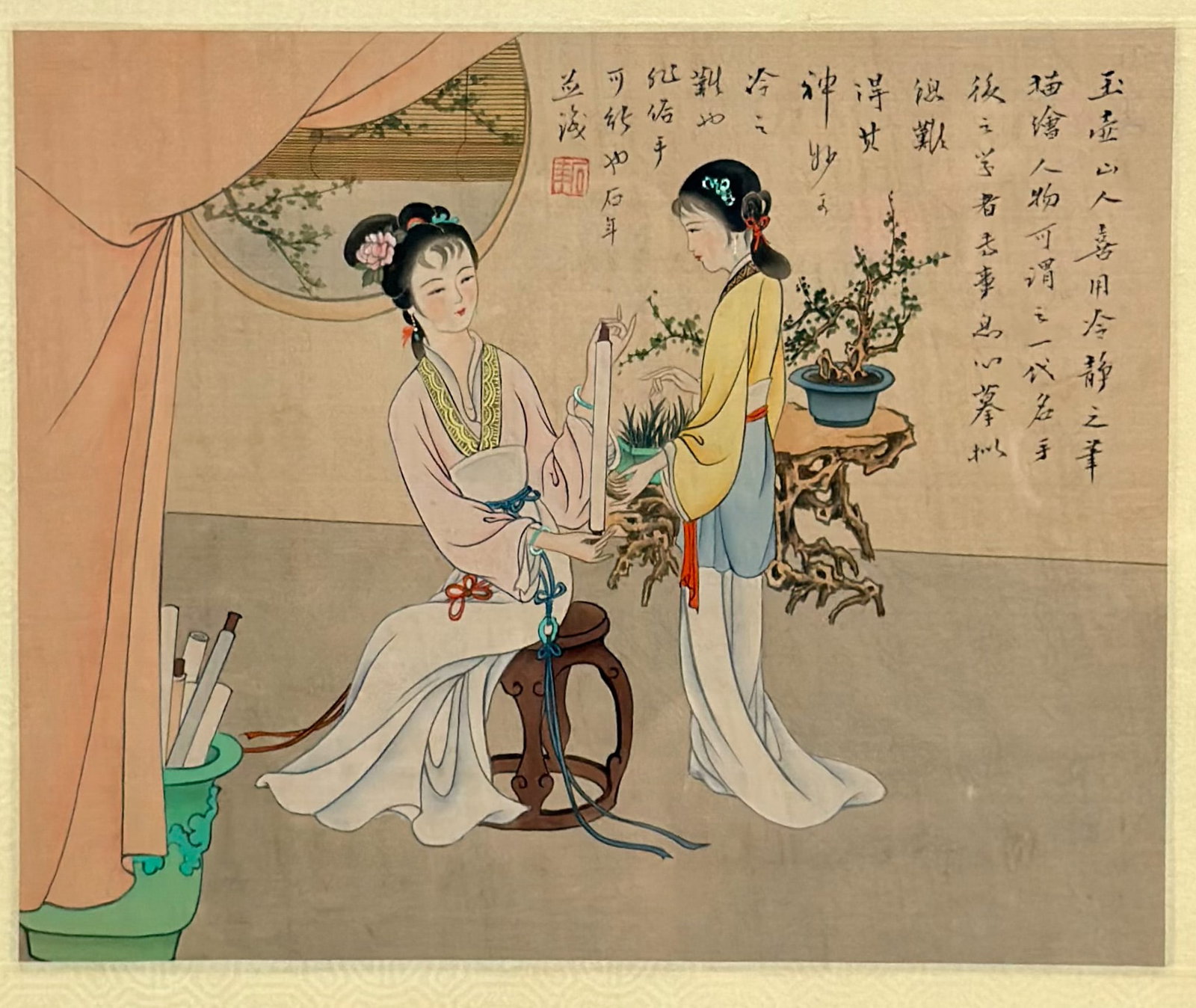 Chinese Print Depicting Two Women in Traditional Clothing: This artwork is a framed Chinese print depicting two women in traditional clothing engaged in refined activities within a scholar's studio. One woman is seated on a dark wood barrel stool holding a ve