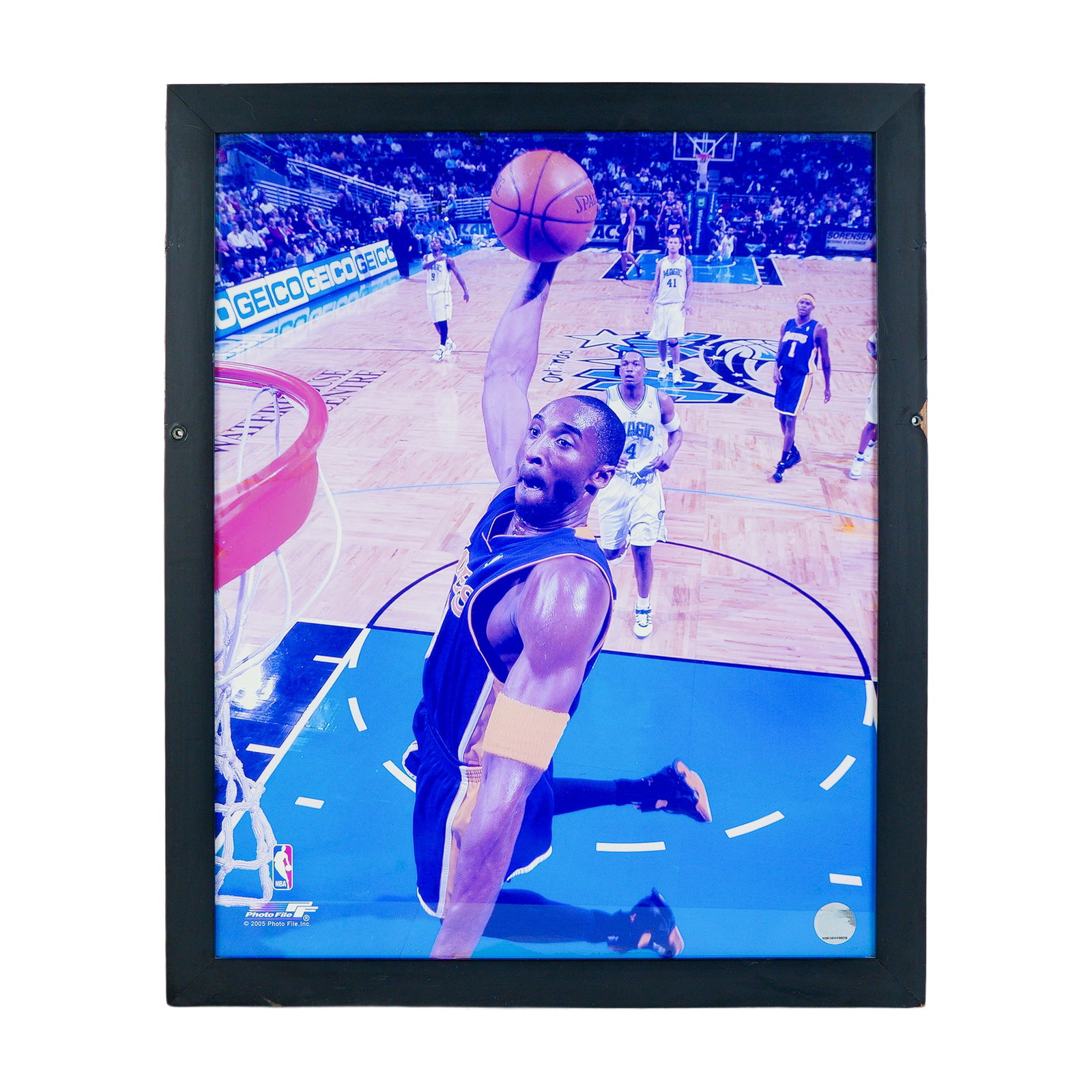 Kobe Bryant Slam Dunk Color Photograph Print w/ NBA Authentication Hologram: An electrifying framed print capturing Kobe Bryant in mid-flight, finishing a thunderous dunk against the Orlando Magic. Kobe Bryant's legacy as one of the greatest to ever play the game makes this a 