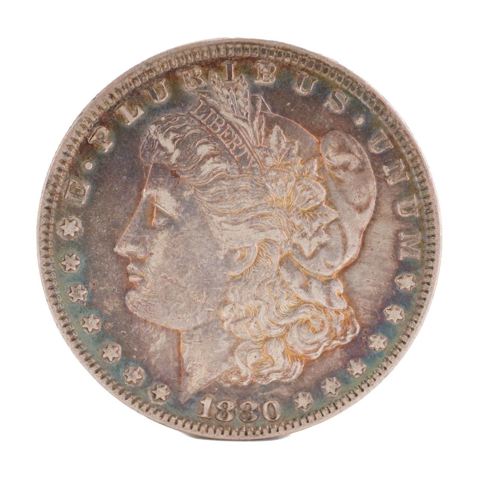 1880 U.S. Morgan Dollar 90% Silver Coin, Circulated: Morgan Dollar with obverse Liberty head, facing left and E PLURIBUS UNUM LIBERTY and date. Revers depicts Eagle holding arrows and an olive branch within wreath. Total weight 28g. Dimensions: 38.1mm D