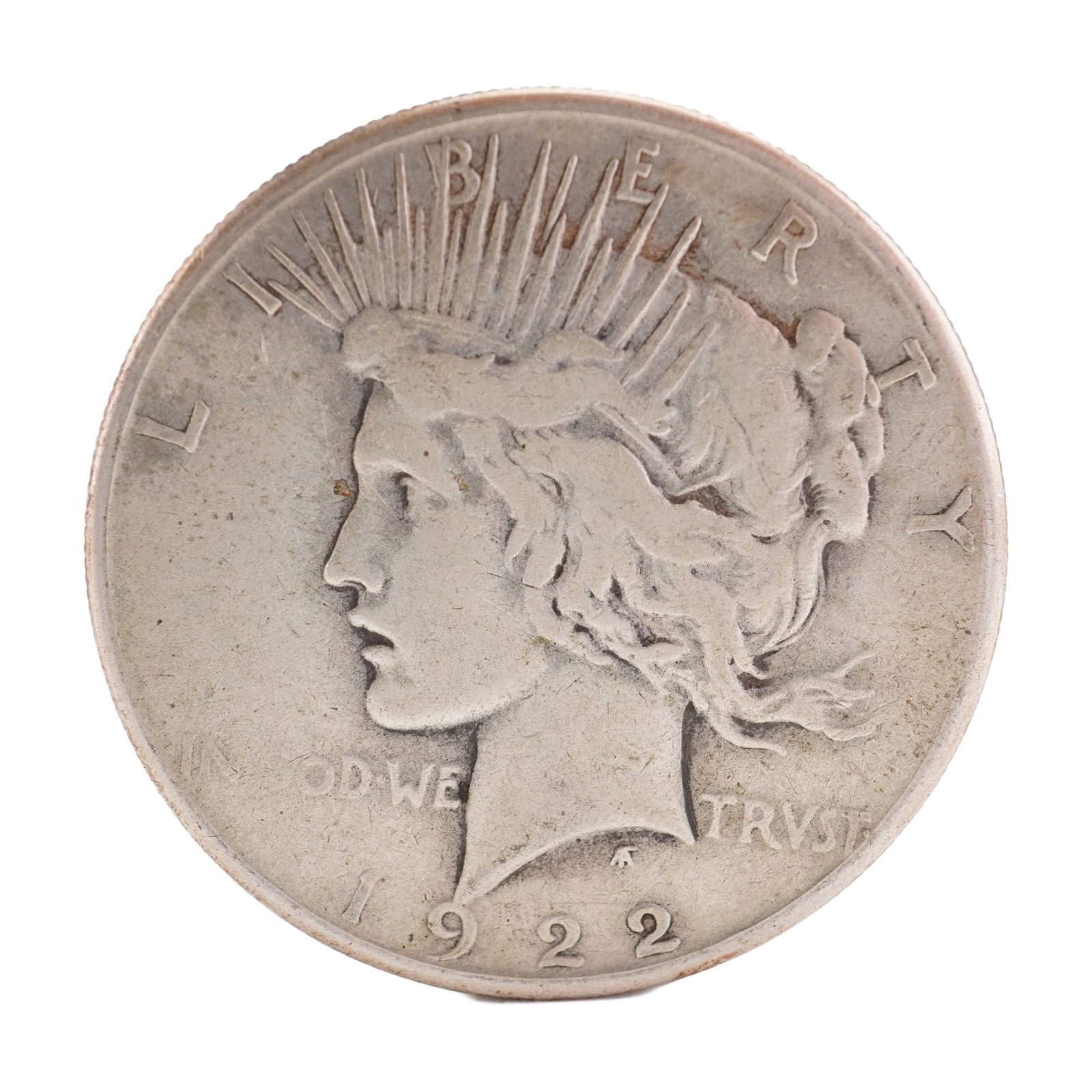 1922 U.S. Peace Dollar 90% Silver Coin, Circulated: Peace dollar designed with obverse capped head of Liberty facing left with headband rays. Reverse has Eagle standing right on rock with wings folded, branch in talons, rays behind and PEACE below. Tot