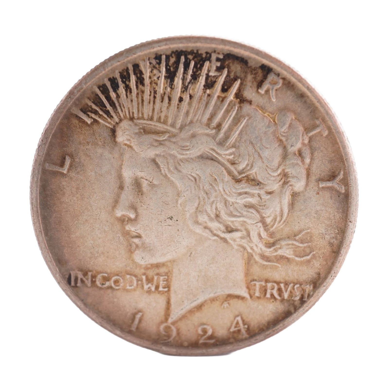 1924 U.S. Peace Dollar 90% Silver Coin, Circulated: Peace dollar designed with obverse capped head of Liberty facing left with headband rays. Reverse has Eagle standing right on rock with wings folded, branch in talons, rays behind and PEACE below. Tot