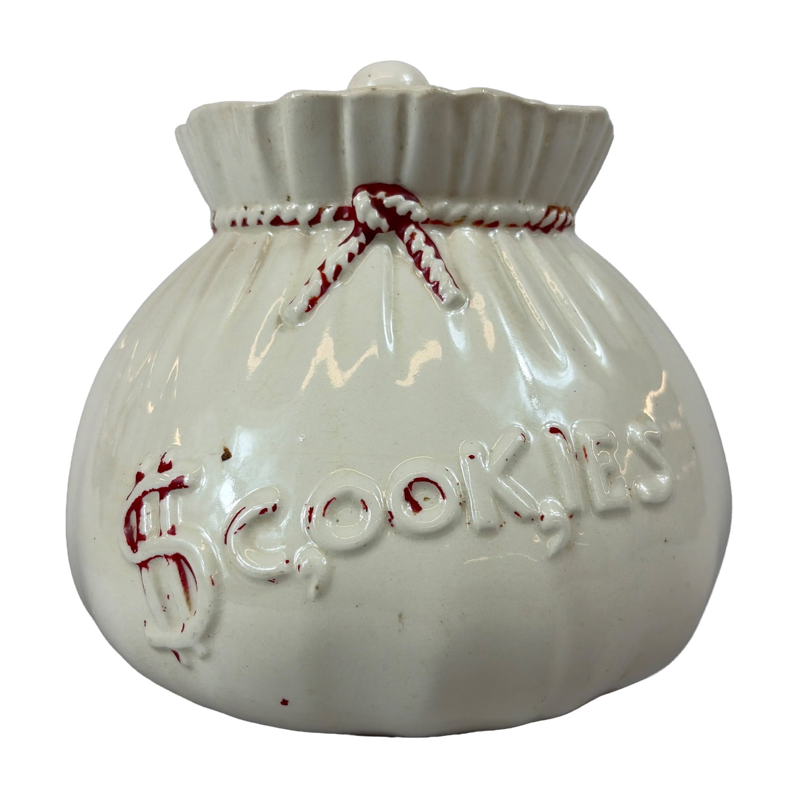 Abingdon Pottery Money Sack Cookie Jar: The form features a fluted body simulating a fabric bag with a ruffled rim and a fitted lid topped by a spherical knob. The front is decorated with embossed lettering spelling COOKIES and a dollar sig