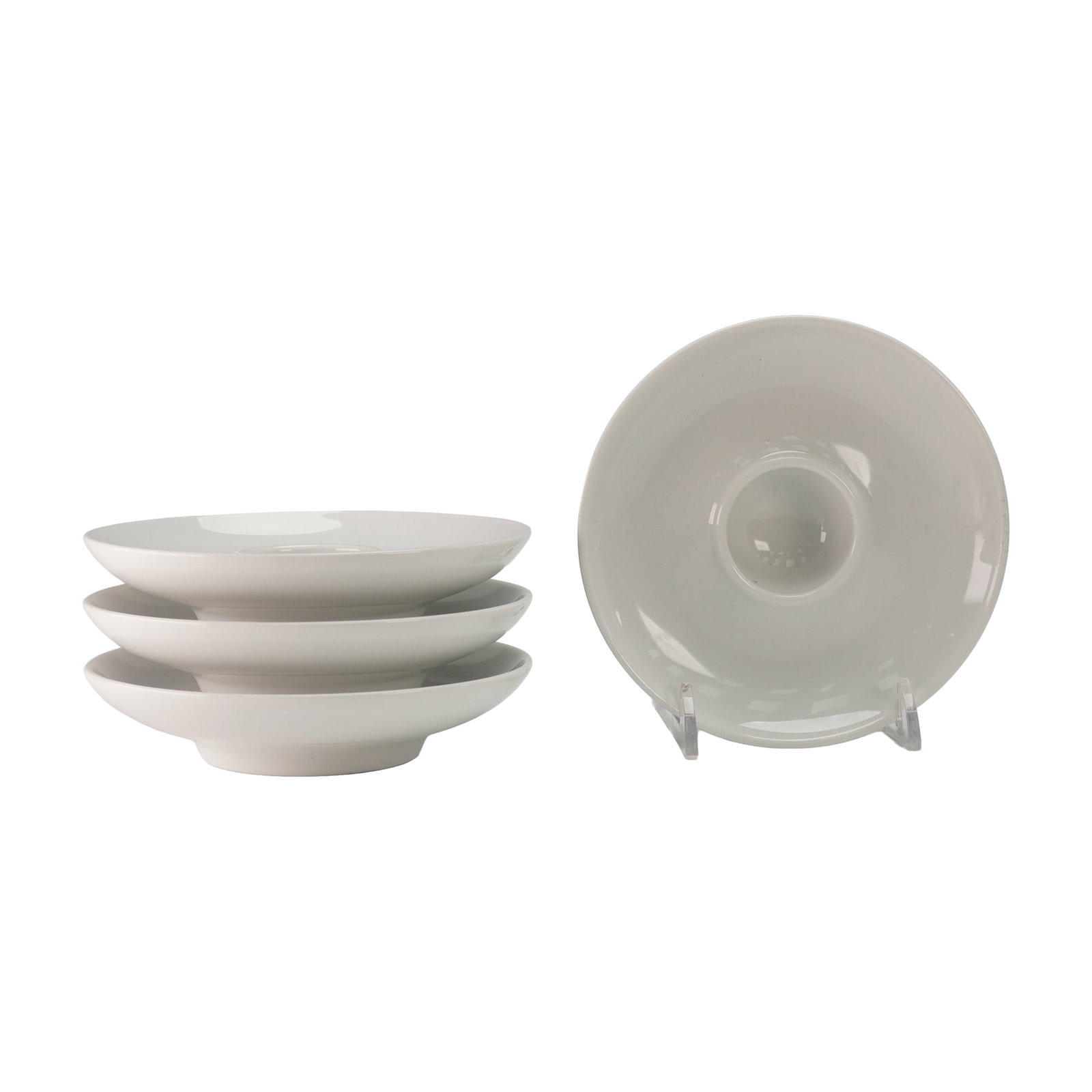 4pc Thomas Rosenthal White Porcelain Candle Holders: Each formed as a shallow circular dish with a raised central well designed to securely accommodate a taper candle, displaying smooth, clean lines and a uniform white glaze; the underside of each piece
