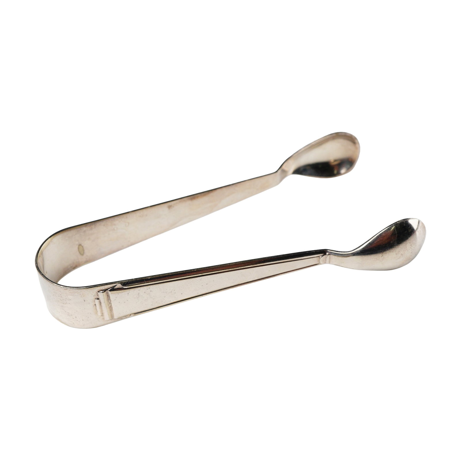 A Pair of Silver Plate Sugar Tongs, Marked R&B: A pair of silver-colored metal sugar tongs, featuring a simple, U-shaped design with unadorned, spoon-shaped grasping ends. The interior surface bears the initials 'R&B', a symbol, and the number '150