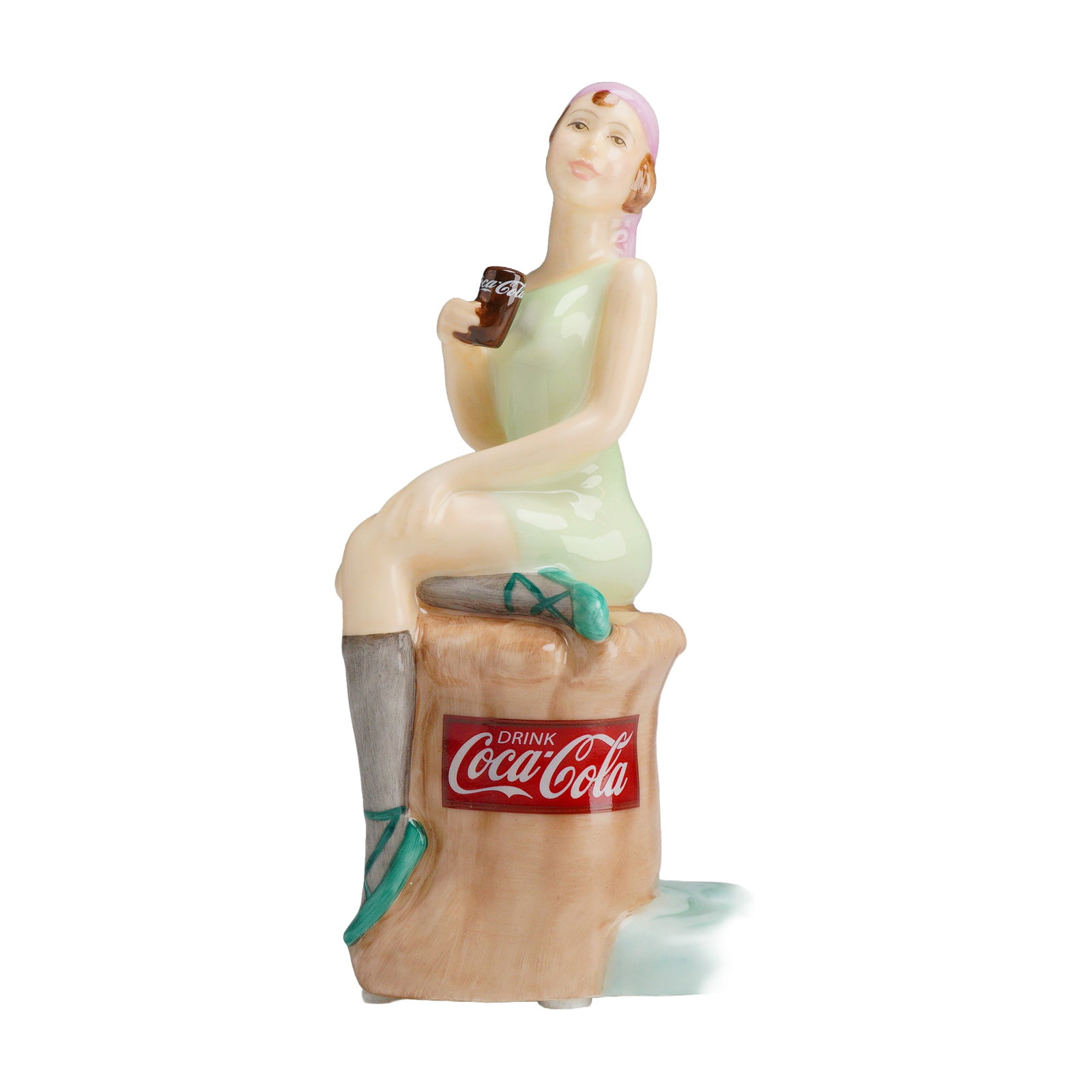 Royal Doulton Coca-Cola Bathing Belle Limited Edition MCL 14 Porcelain Figurine: A limited edition porcelain figurine titled Coca-Cola Bathing Belle, produced by Royal Doulton in collaboration with The Coca-Cola Company as part of the Calendar Girls series. This hand-decorated fig