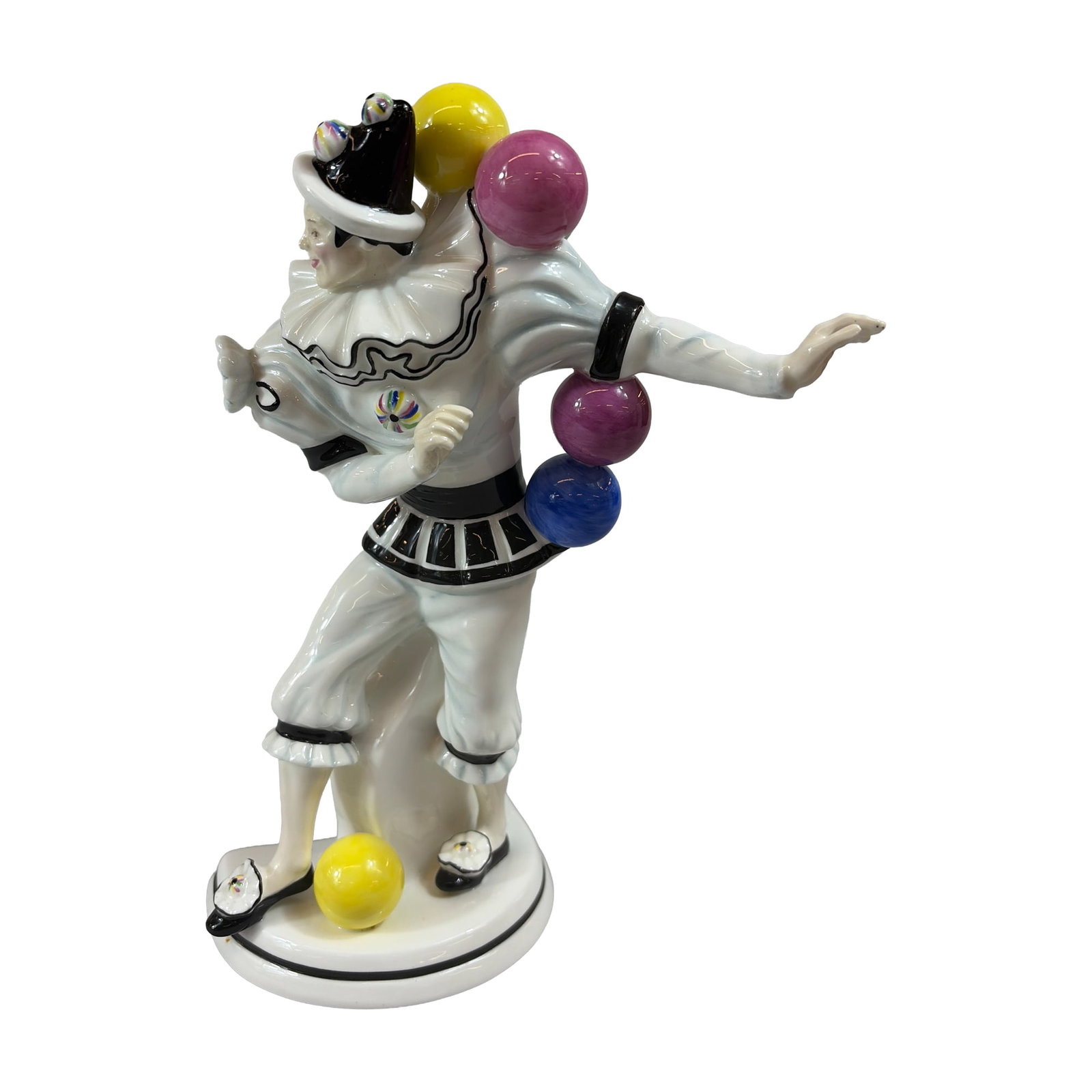 Royal Doulton Prestige Balloon Clowns Fine China Figurine, Trickster HN5308: The dynamically posed pierrot figure is fashioned in a white clown costume with black-ruffed trim, a striped waist, and a decorated black and white hat, depicted balancing multiple colorful spheres in