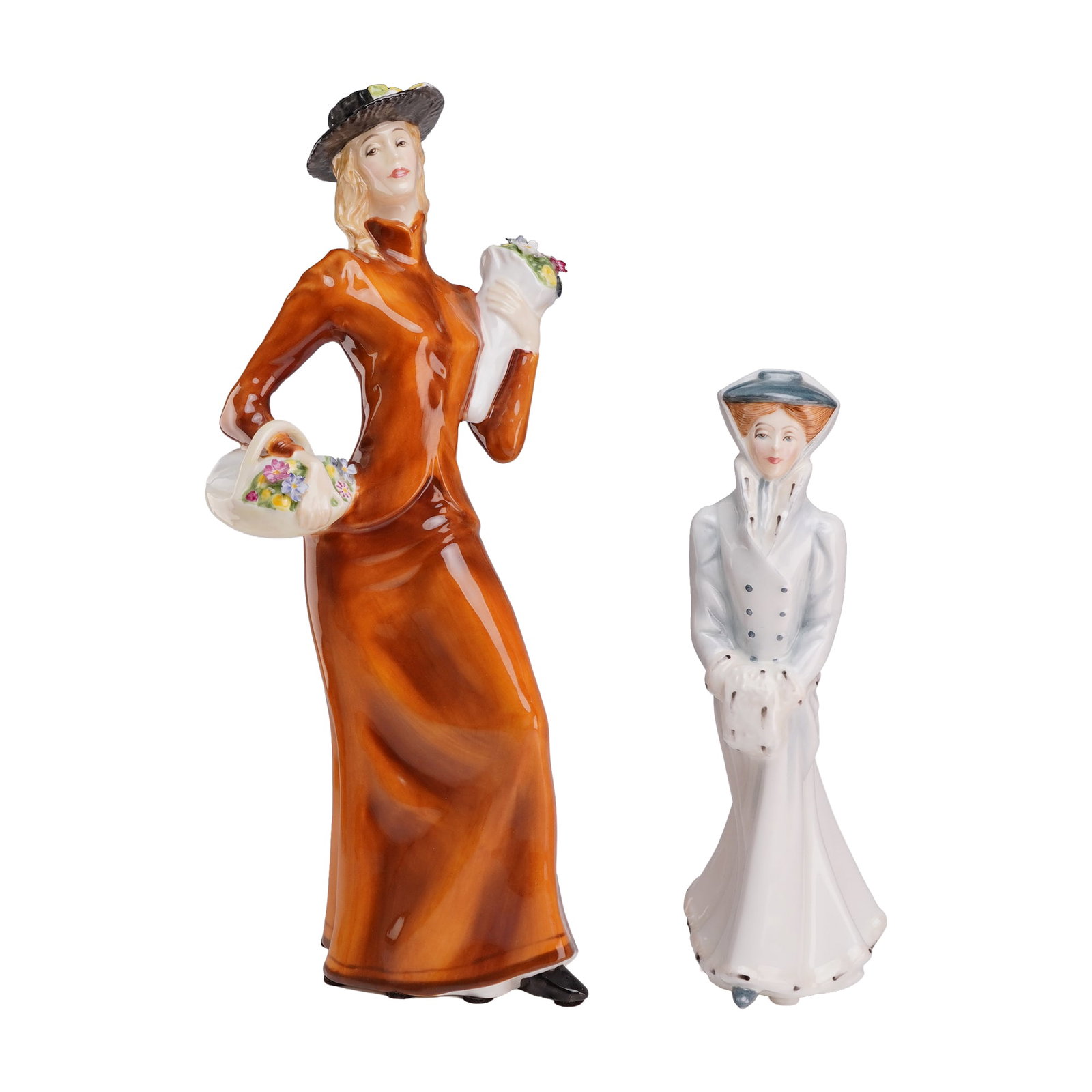 Two Royal Doulton Figurines, Eliza HN 2543 and Sarah in Winter HN3005: The larger figurine, titled Eliza (HN 2543), is rendered in glazed porcelain and depicts a woman in an Edwardian-style rust-colored jacket and matching floor-length skirt. She wears a black hat adorne