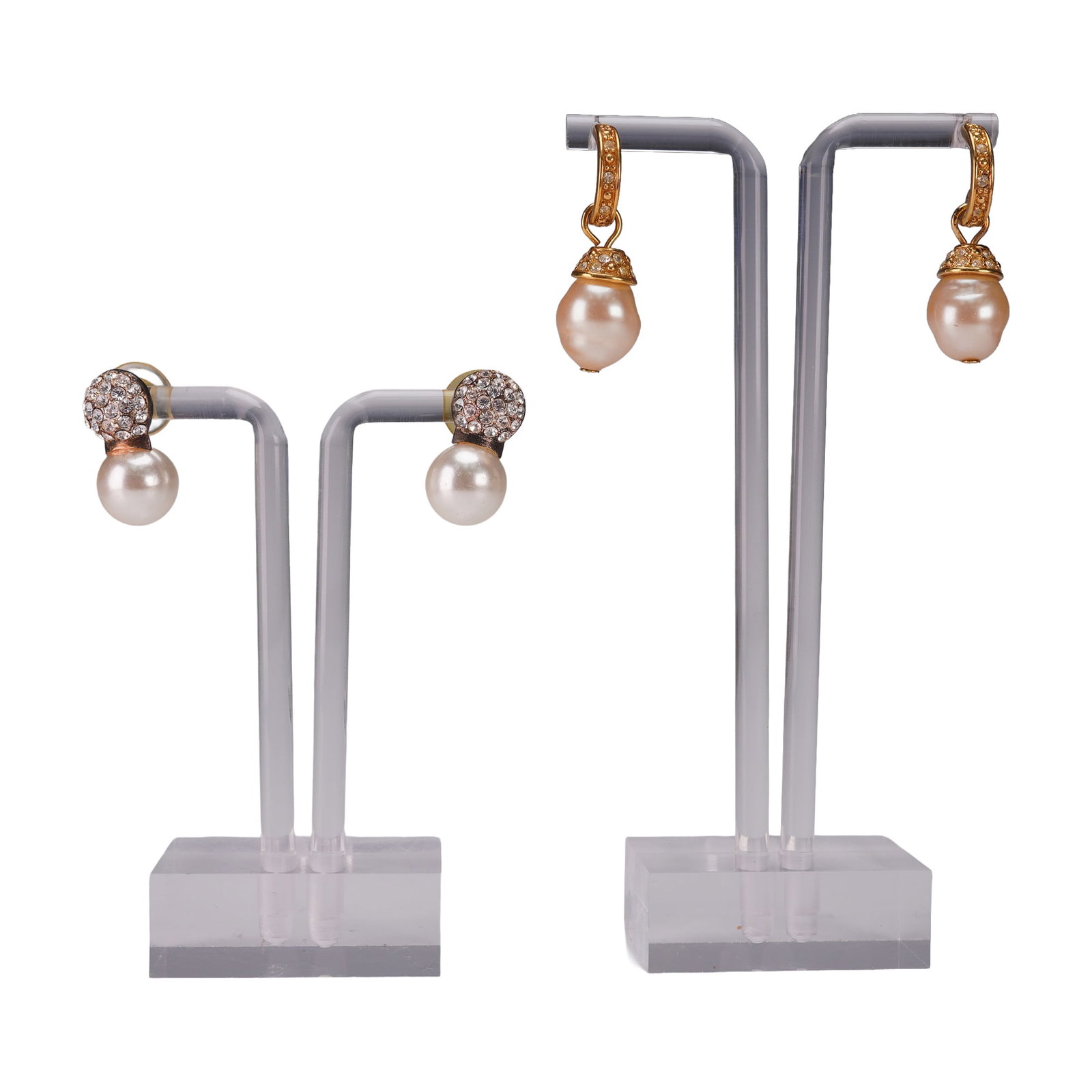 2 Pair Rhinestone and Faux Pearl Earrings: Group of two pairs of glamorous rhinestone accented earrings. The first pair features luminous faux pearls suspended from pave rhinestone caps set in a goldtone mount, offering a chic drop design. The