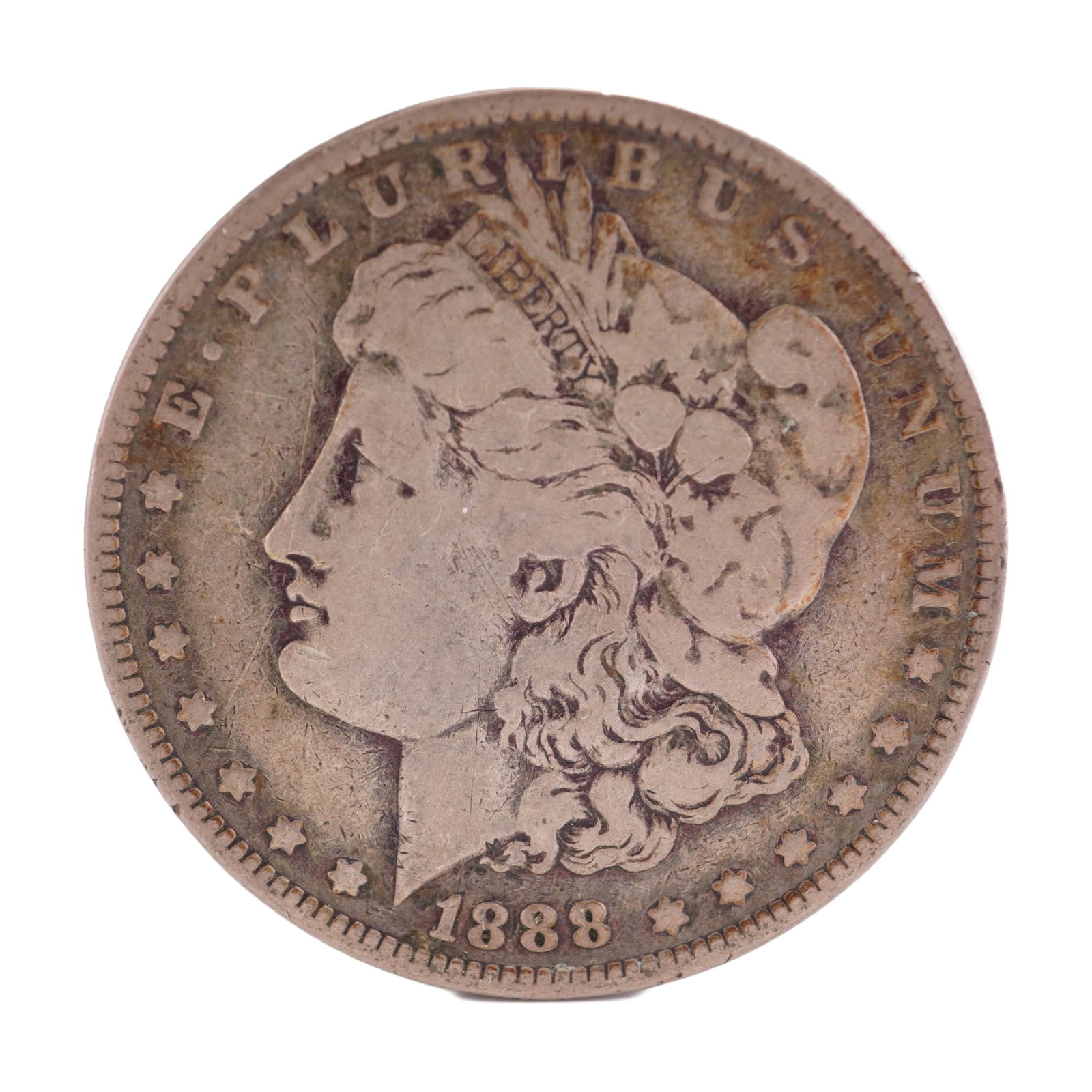 1888 U.S. Morgan Dollar 90% Silver Coin, Circulated: Morgan Dollar with obverse Liberty head, facing left and E PLURIBUS UNUM LIBERTY and date. Revers depicts Eagle holding arrows and an olive branch within wreath. Total weight 26g. Dimensions: 38.1mm D