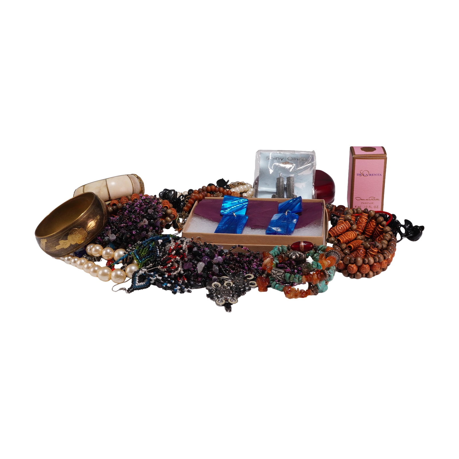 Collection of Vintage Costume Jewelry and Vanity Items: An assortment of vintage costume jewelry and vanity pieces featuring a variety of materials and cultural themes. The collection includes a boxed 4 ml bottle of Oscar de la Renta Parfum in a pink and g