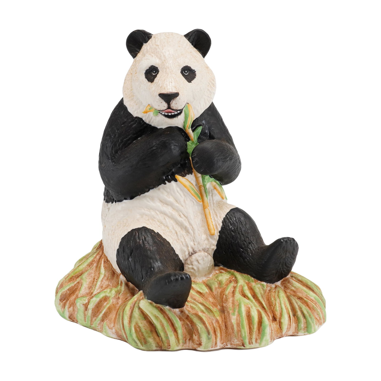 Royal Doulton Endangered Species Porcelain Figurine, Panda DA150: Designed by sculptor Warren Platt, this hand-decorated figure depicts a seated giant panda eating a stalk of bamboo. The piece is set upon a textured base modeled as a grassy mound. The surface is fin