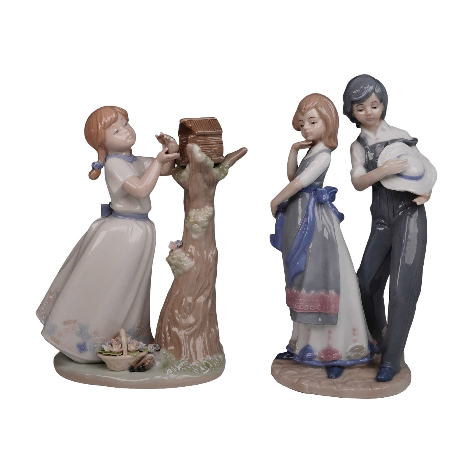 A Pair of Glazed Ceramic Figurines, one by Nadal, depicting children: A pair of Spanish glazed ceramic figurines. The first figurine, marked 'NADAL' with a crown logo, 'MADE IN SPAIN,' and 'LIMITED EDITION N? 1344 / 5000,' depicts a young girl with reddish-brown pigtail