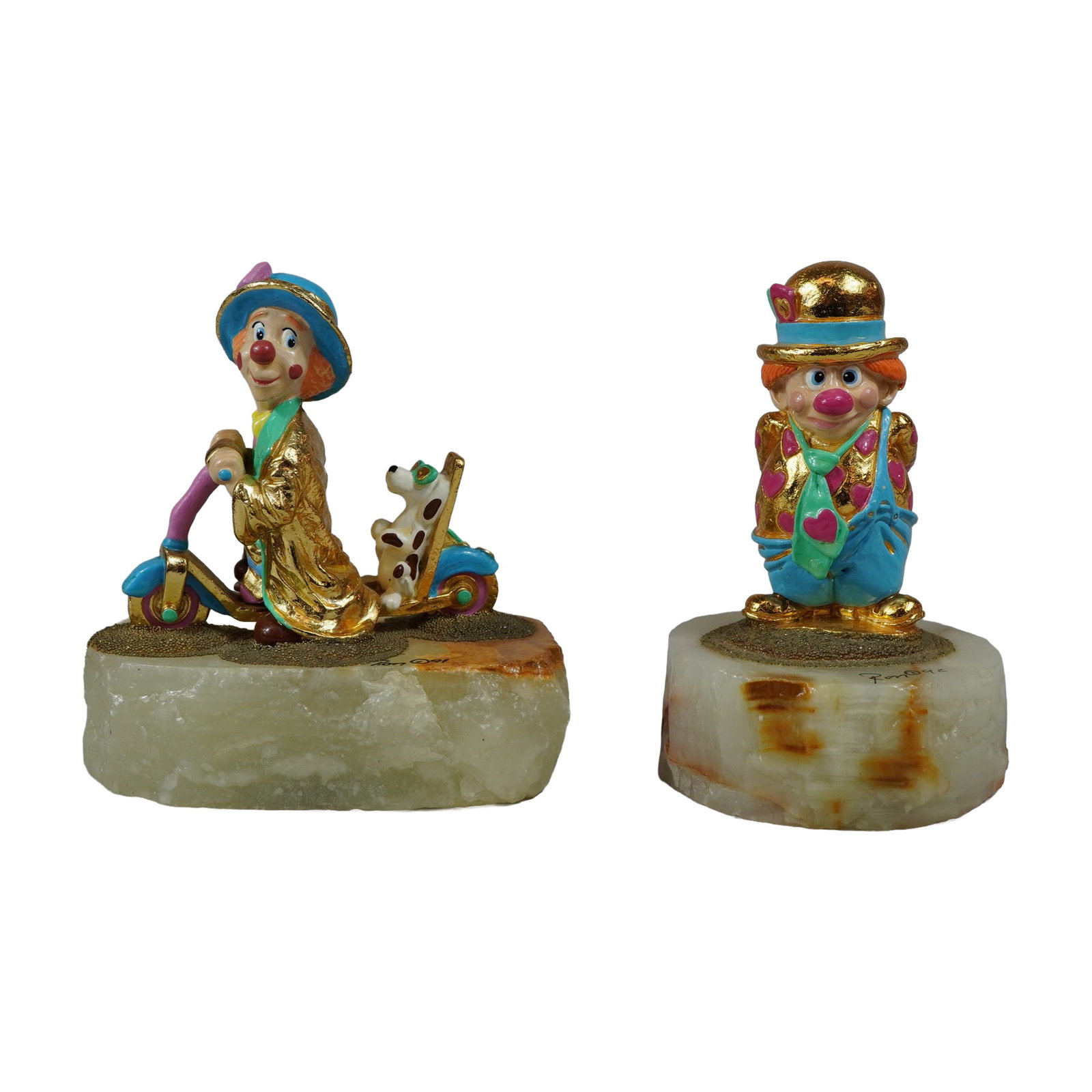 2pc Ron Lee Gilt Metal Clown Sculptures: Pair of cast metal clown sculptures by artist Ron Lee (American, 1947-2017). Each figure is finished in 24 karat gold plating with hand-painted enamel details, mounted on a polished, irregular onyx ba