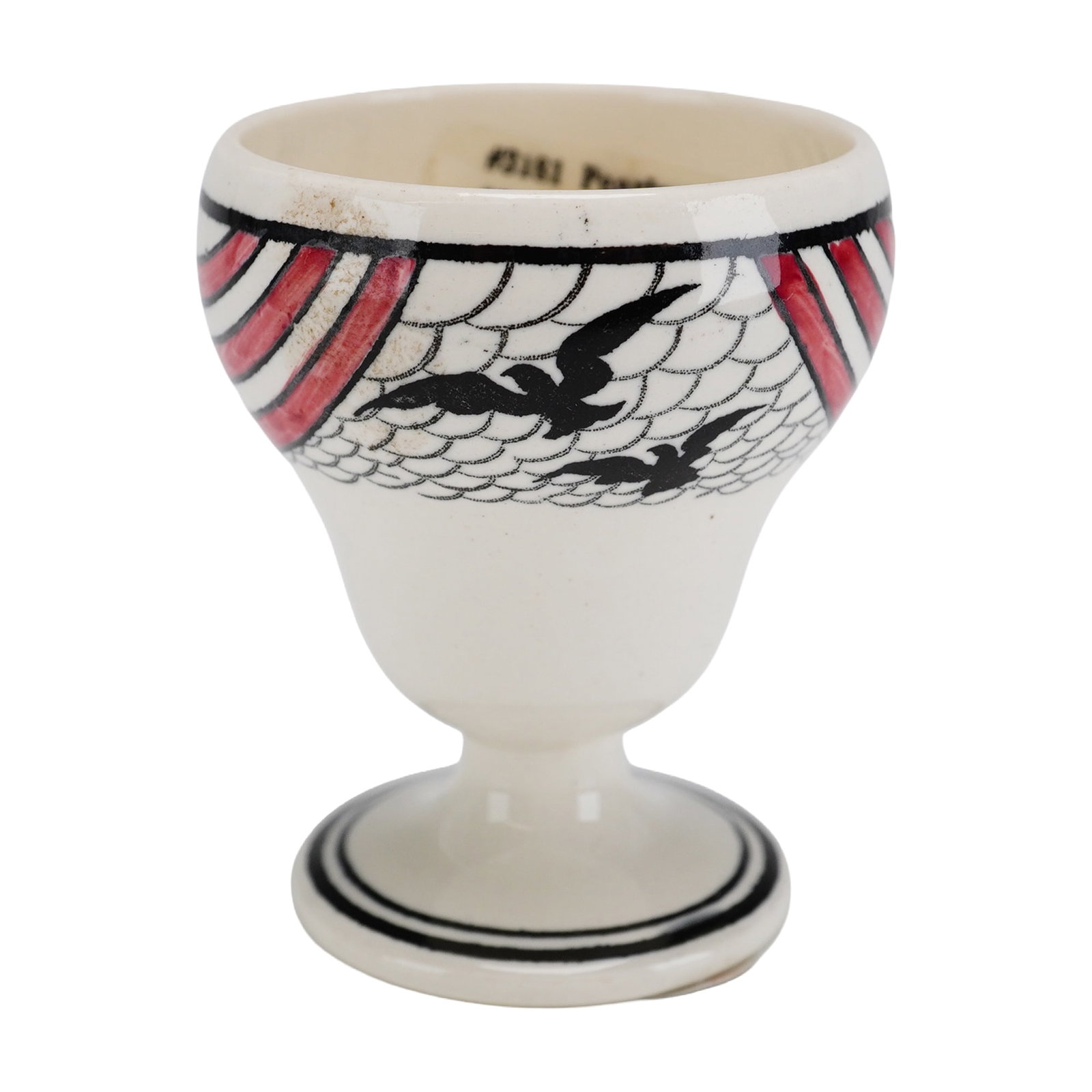 Wedgwood Etruria Pearlware Egg Cup, Sunbirds Pattern, ca 1931: The piece features a flared, rounded bowl set upon a double-banded circular foot. The exterior is decorated with a hand-painted Art Deco design featuring two black birds in flight against a fine black