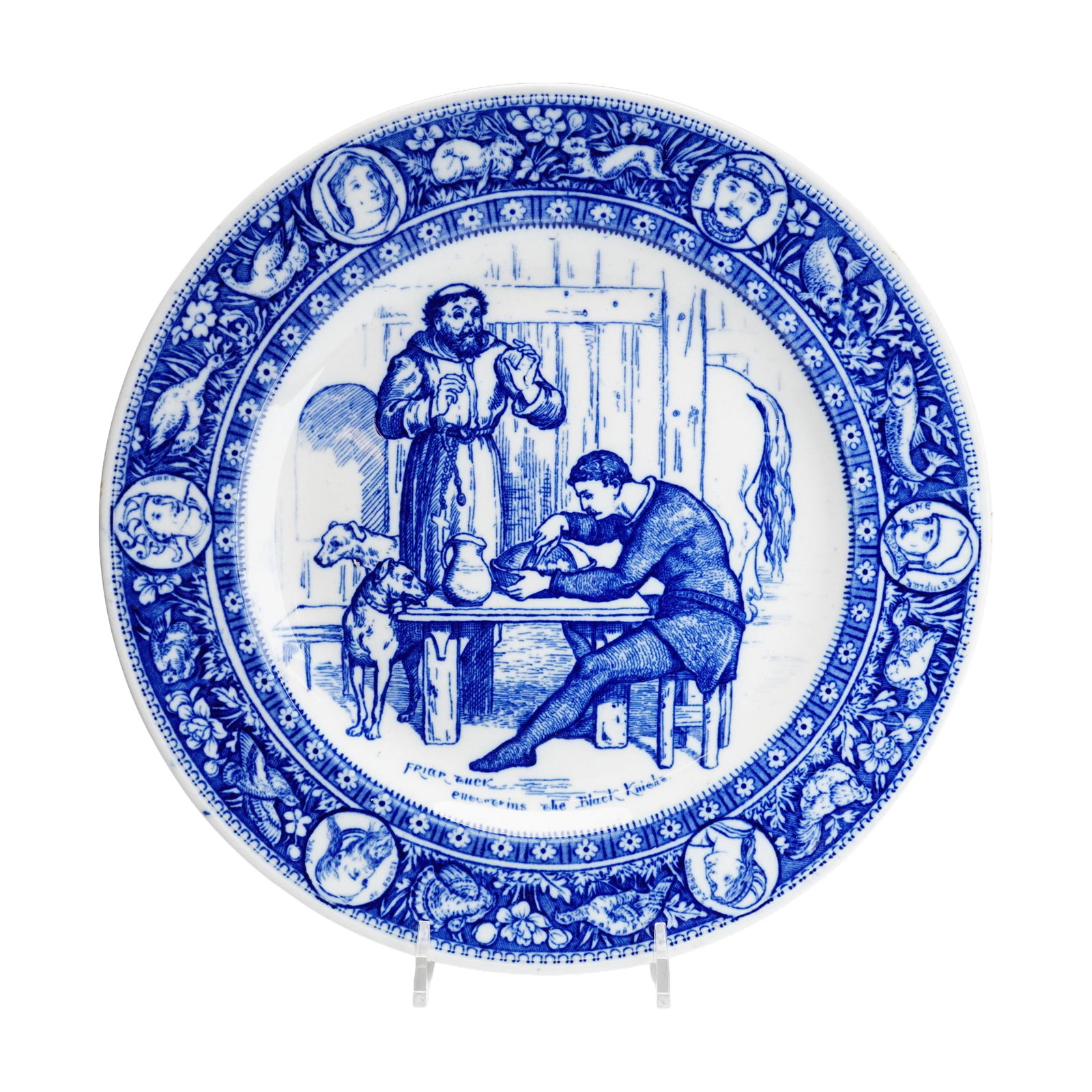 Wedgwood Ivanhoe Series Friar Tuck Entertains the Black Knight Blue Transferware Plate: This is a Wedgwood blue transfer-printed earthenware plate from the Ivanhoe series, which was inspired by the 1819 novel by Sir Walter Scott. The central well features a scene captioned Friar Tuck ent