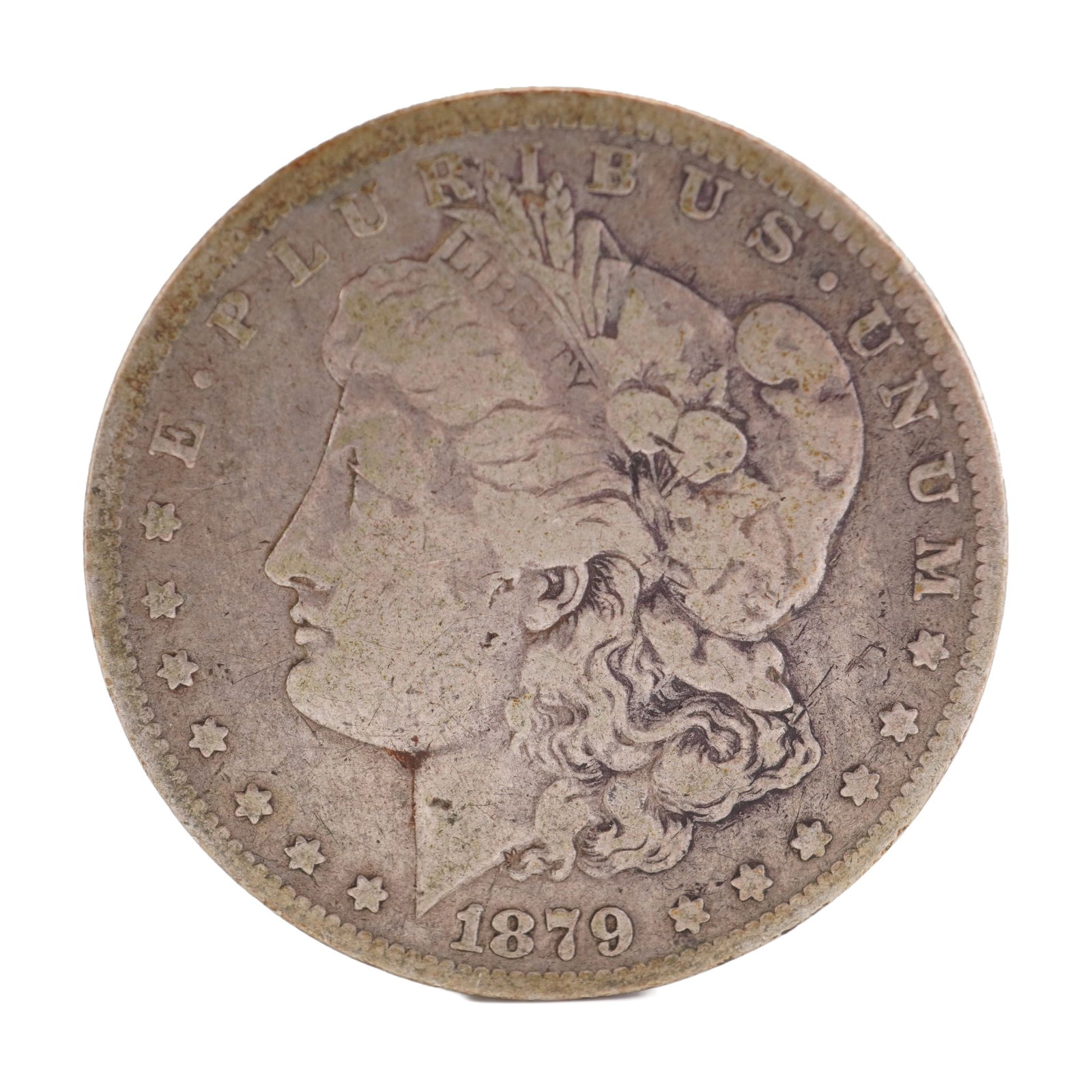 1879 U.S. Morgan Dollar 90% Silver Coin, Circulated: Morgan Dollar with obverse Liberty head, facing left and E PLURIBUS UNUM LIBERTY and date. Revers depicts Eagle holding arrows and an olive branch within wreath. Total weight 26g. Dimensions: 38.1mm D