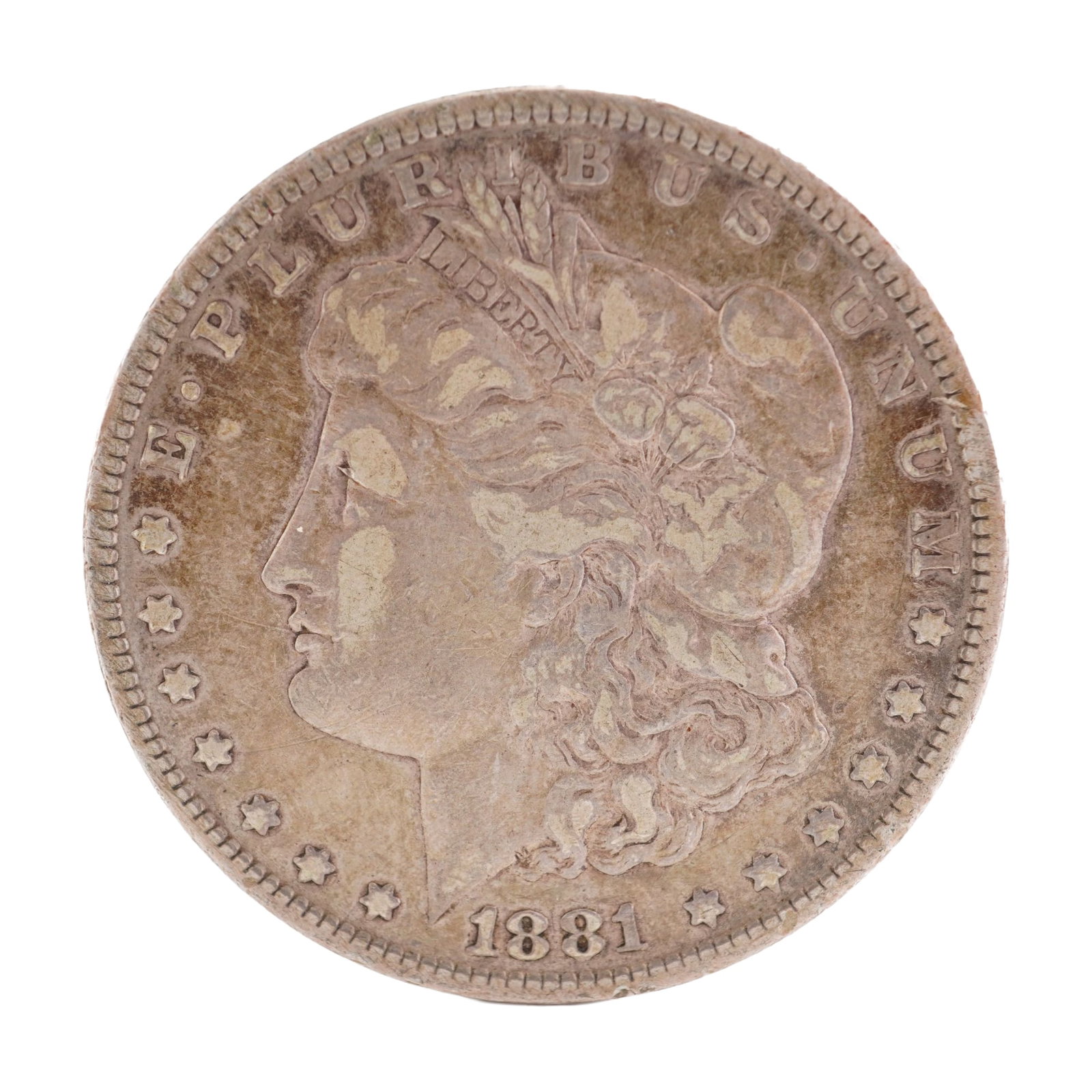 1881 U.S. Morgan Dollar 90% Silver Coin, Circulated: Morgan Dollar with obverse Liberty head, facing left and E PLURIBUS UNUM LIBERTY and date. Revers depicts Eagle holding arrows and an olive branch within wreath. Total weight 26g. Dimensions: 38.1mm D
