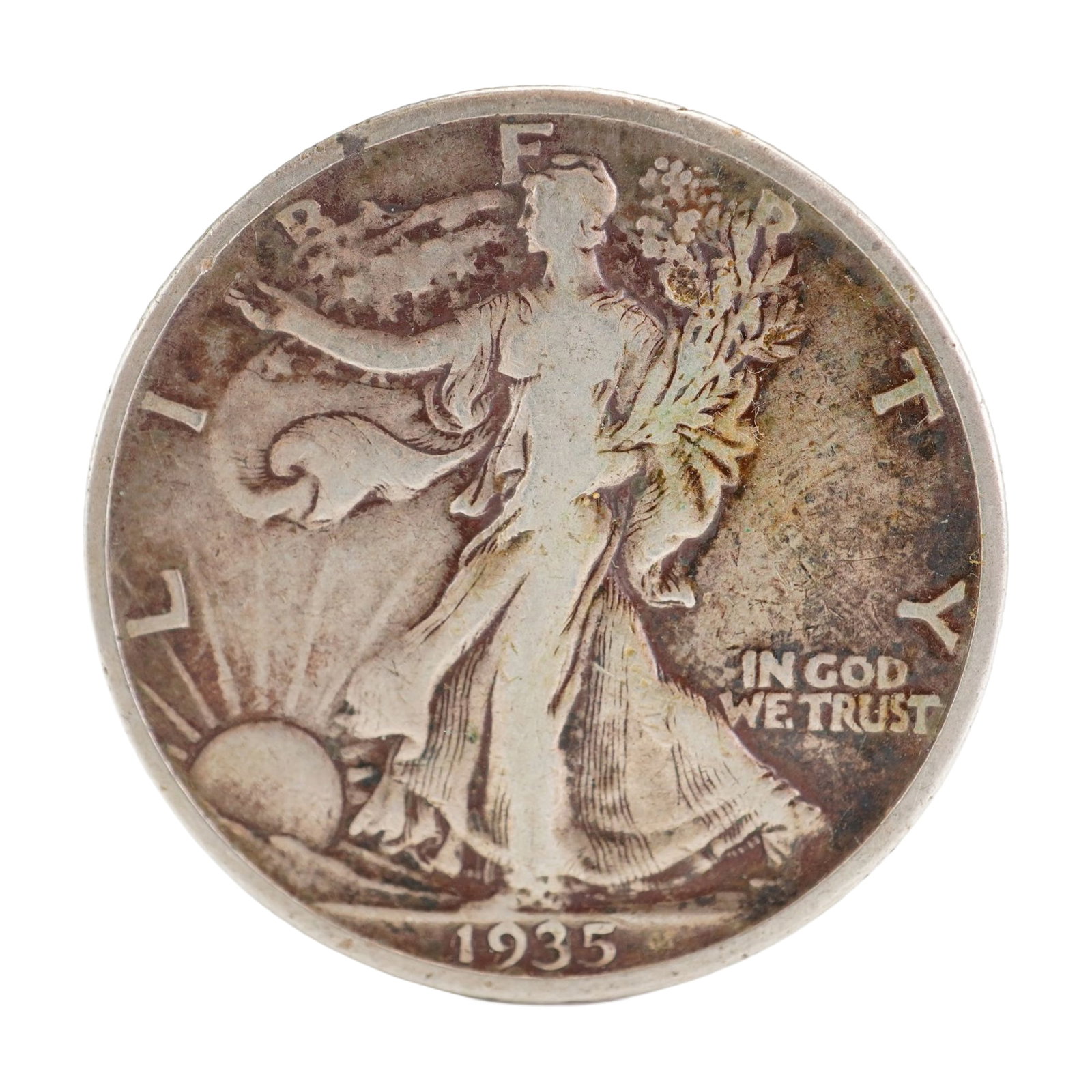 1935 U.S. Walking Liberty Half Dollar 90% Silver Coin, Circulated: Design includes obverse Liberty walking to the left with date below; Reverse has Eagle with wings spread and denomination below. Total weight 12g. Dimensions: 30.6mm Date or Era: 1935 Country of Origi