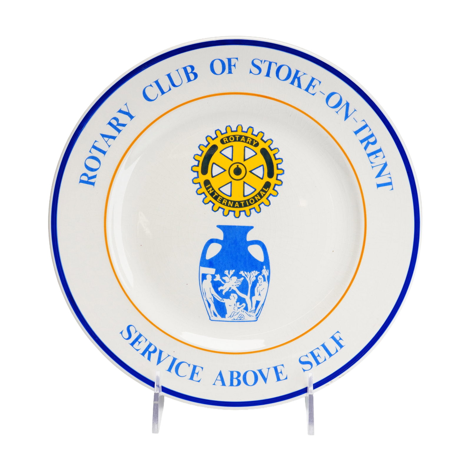 Rotary Club of Stoke-on-Trent Commemorative Ceramic Plate: A commemorative ceramic plate produced for the Rotary Club of Stoke-on-Trent. The face of the plate features blue and orange concentric rings bordering the rim. The upper rim is inscribed with the tex