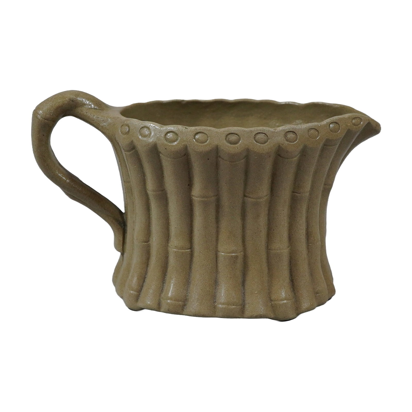 Wedgwood Drabware Cream Jug, Bamboo Pattern: A Wedgwood relief-molded cream jug in the bamboo pattern. This vessel is constructed from drabware, a fine-grained, unglazed stoneware characterized by its muted tan color. The exterior body is decora