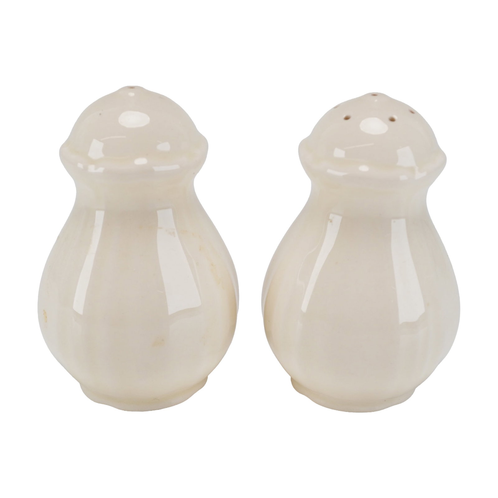 Pair of Wedgwood Creamware Salt and Pepper Shakers: The set is designed in the Queens Plain pattern, featuring a bulbous, pear-shaped body with subtle vertical fluting. Both pieces are finished in a traditional off-white cream glaze. One shaker is desi
