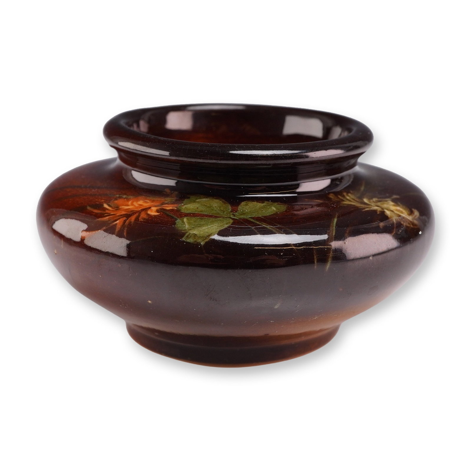 Weller Louwelsa Pottery Squat Vase: Weller Pottery Louwelsa line squat cabinet vase in earthenware, featuring a high-gloss brown glaze with hand-painted slip decoration of a clover blossom and leaves. The piece exhibits a dark chocolate