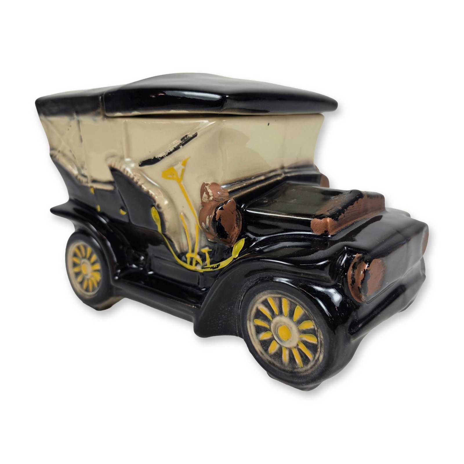 McCoy Ceramic Touring Car Cookie Jar: Lidded cookie jar in glazed earthenware, modeled in the form of an early 20th-century touring car or jalopy. The piece features a black glazed body with a cream-toned convertible top and interior. Dec