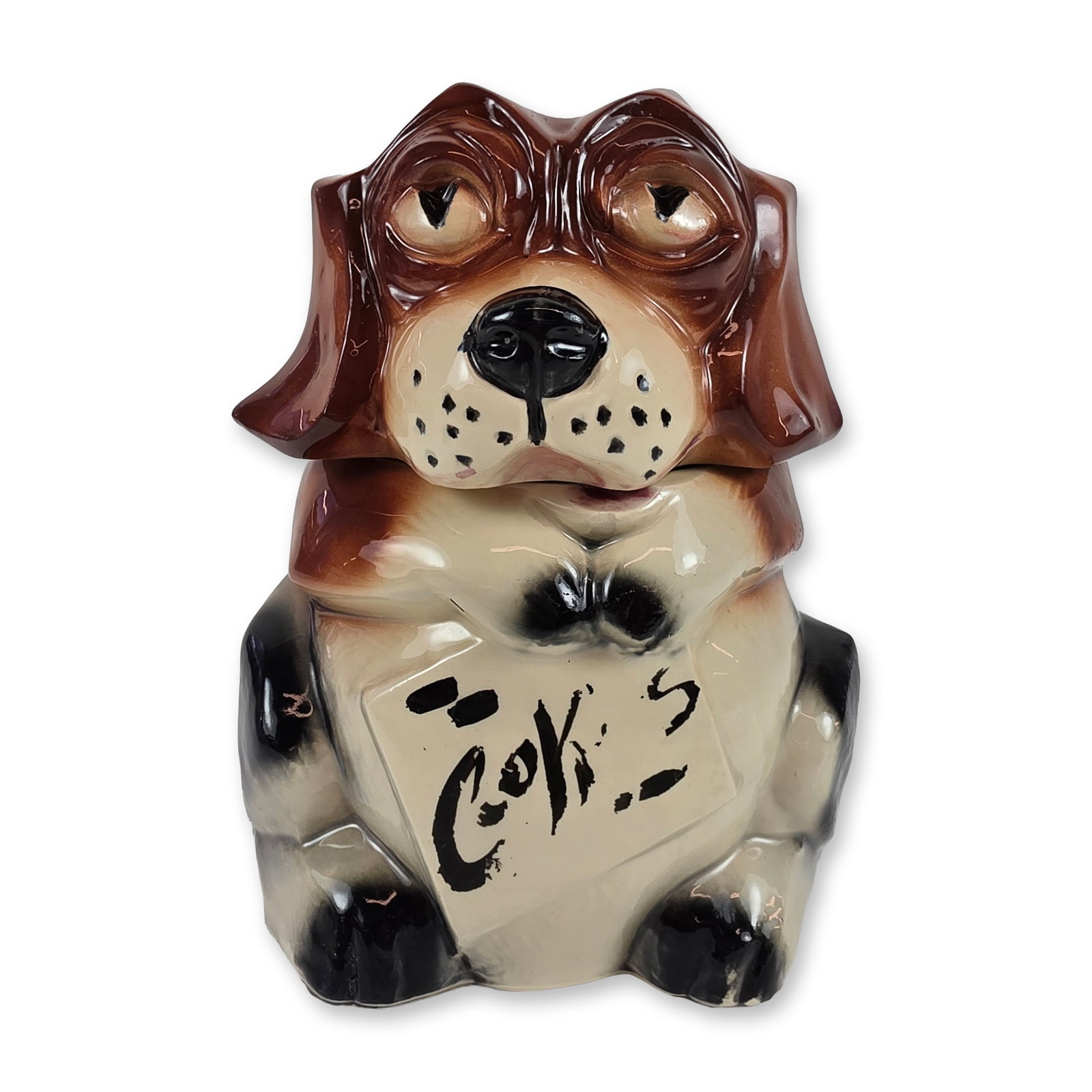 McCoy Pottery Ceramic Beagle Dog Cookie Jar: McCoy Pottery, Nelsonville, Ohio. Cookie jar in glazed ceramic, modeled in the form of a seated beagle or hound dog with a distinctive droopy-eyed expression. The piece features a high-gloss mottled g