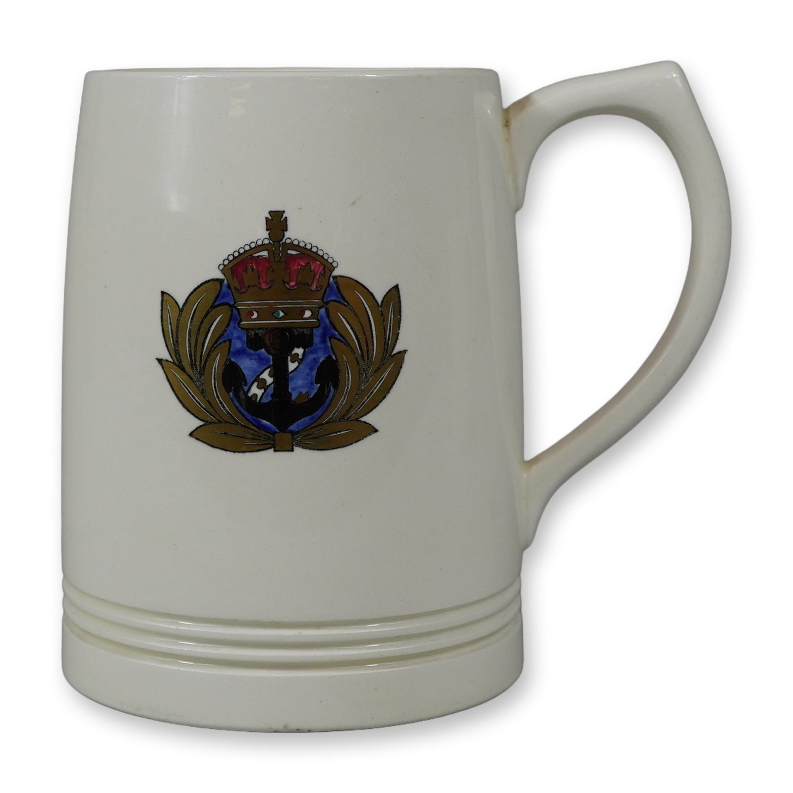 Wedgwood Earthenware Mug with Crown and Anchor Crest: This earthenware mug was manufactured by Wedgwood at the Barlaston factory in England. The piece is constructed of cream-colored earthenware, commonly known as Queen's Ware. The front of the vessel fe